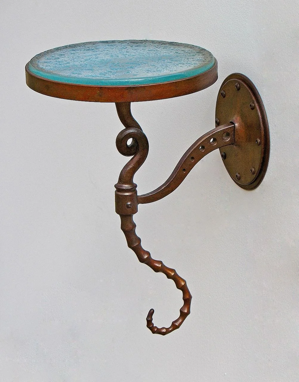 Sculptural, steampunk biomorphic forged iron sconce table with cast glass top