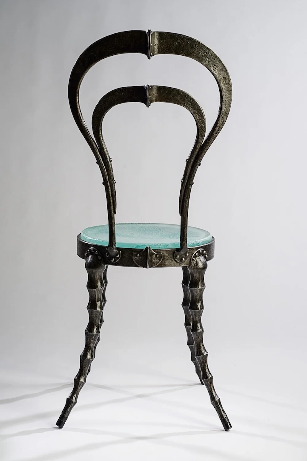 Forged iron steampunk cafe chair with cast glass seat