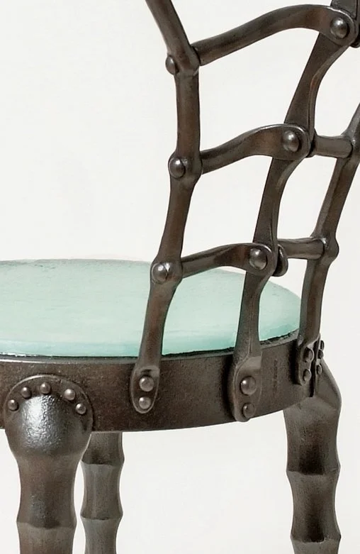 Sculptural steampunk hand forged iron cafe chair with cast glass seat