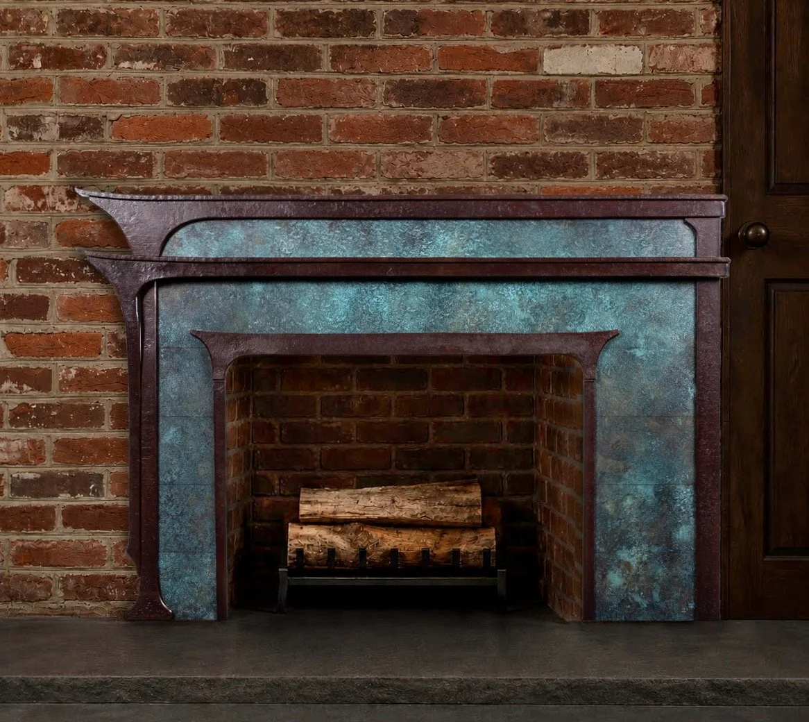 Forged iron and bronze mantelpiece on a brick wall