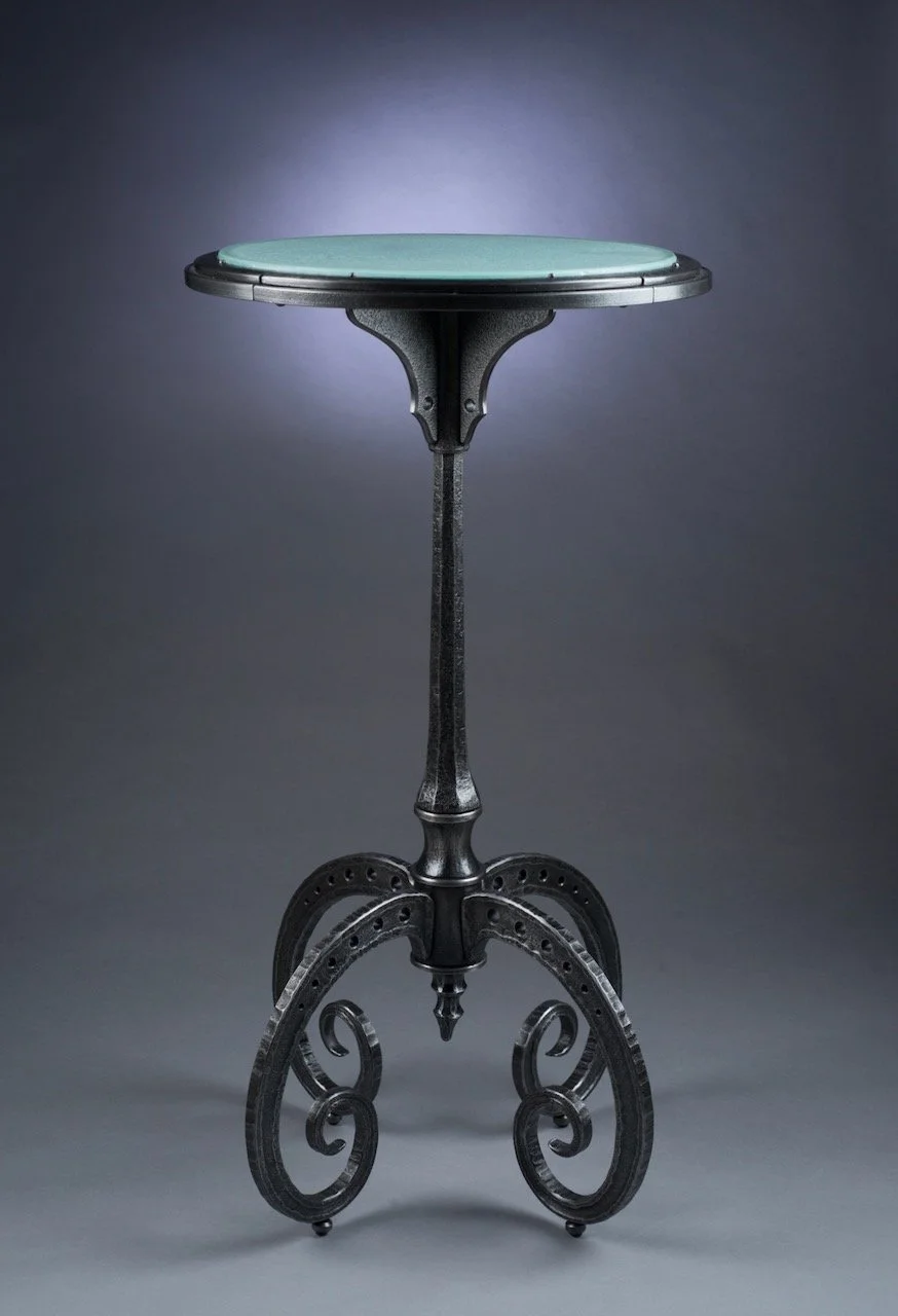 Sculptural, steampunk biomorphic forged iron table with cast glass roundtop