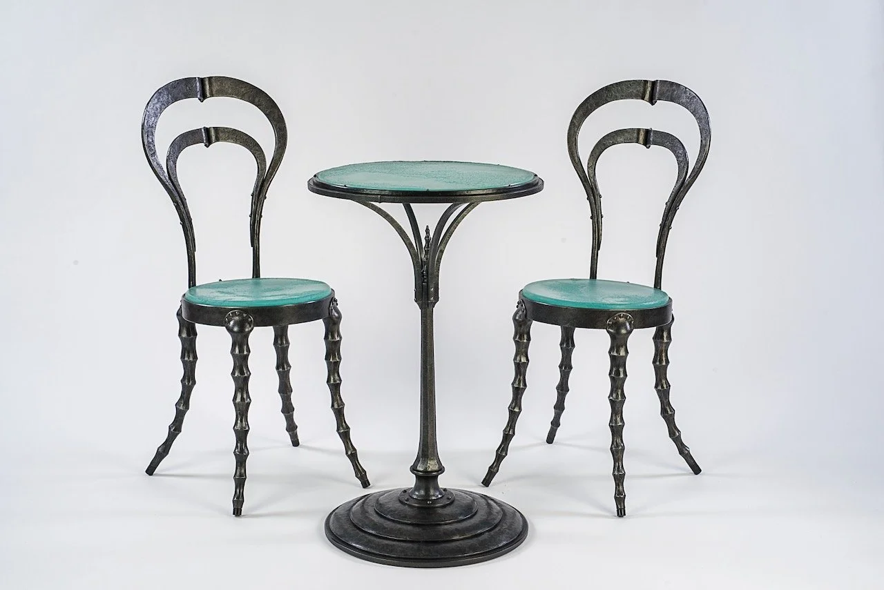 Forged iron steampunk cafe chair and pedestal table with cast glass seat