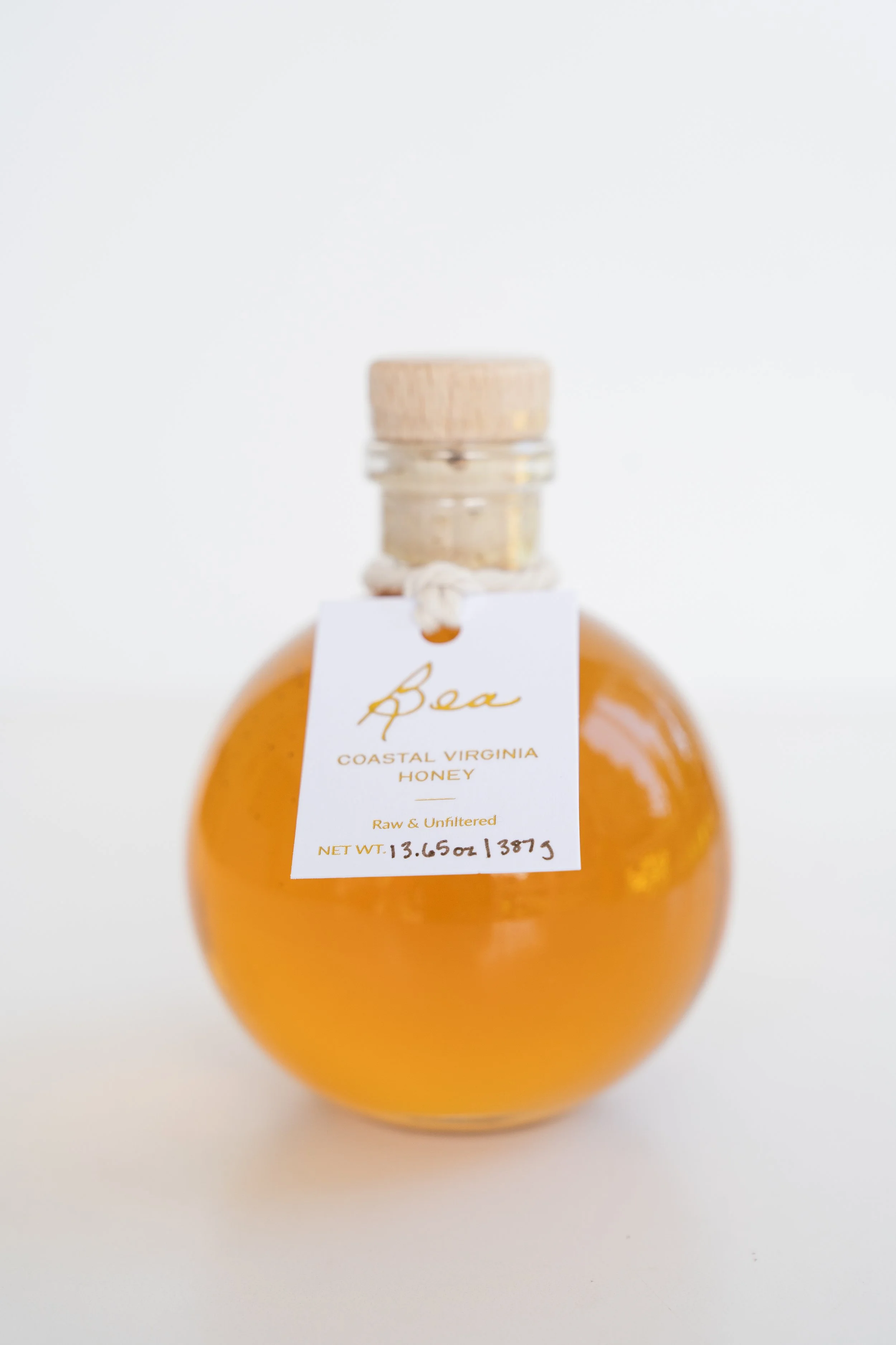 glass jar of honey with cork lid