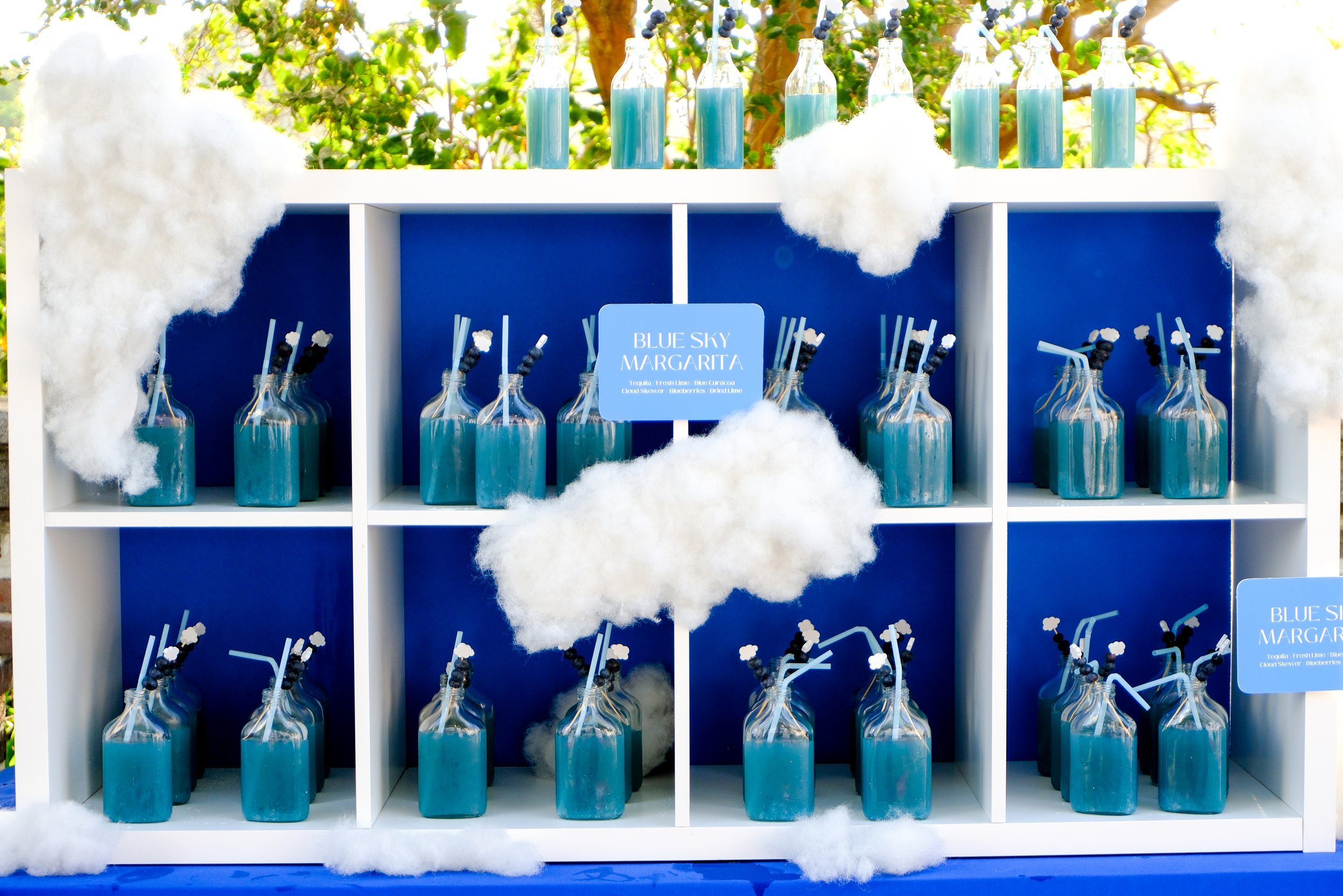 Blue margaritas being served in a "drink wall"