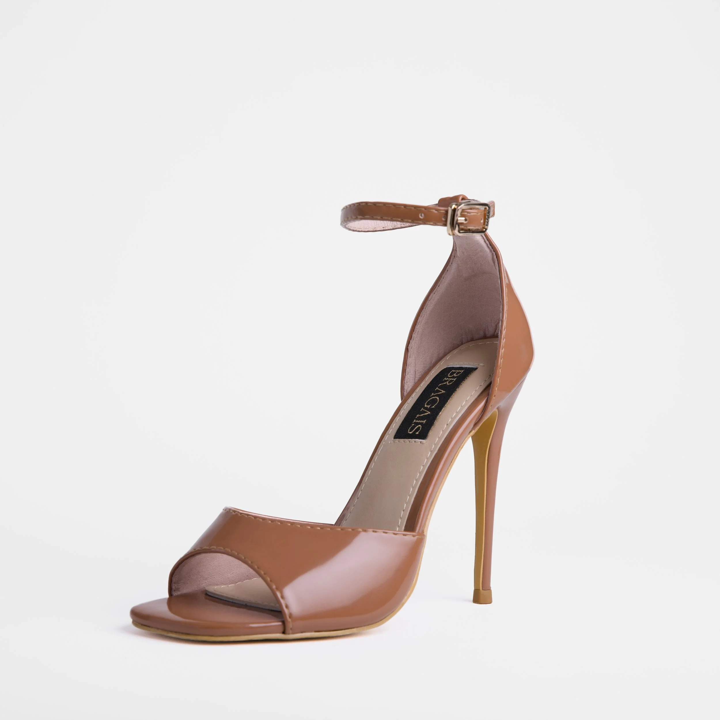 A tan high-heeled pageant shoe with an ankle strap and a stiletto heel, presented against a plain white background.