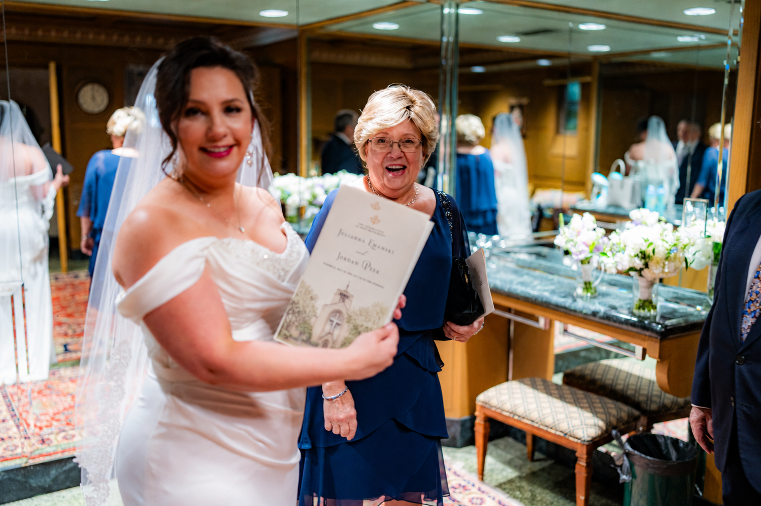 Bride holding her custom Catholic wedding program on her wedding day.