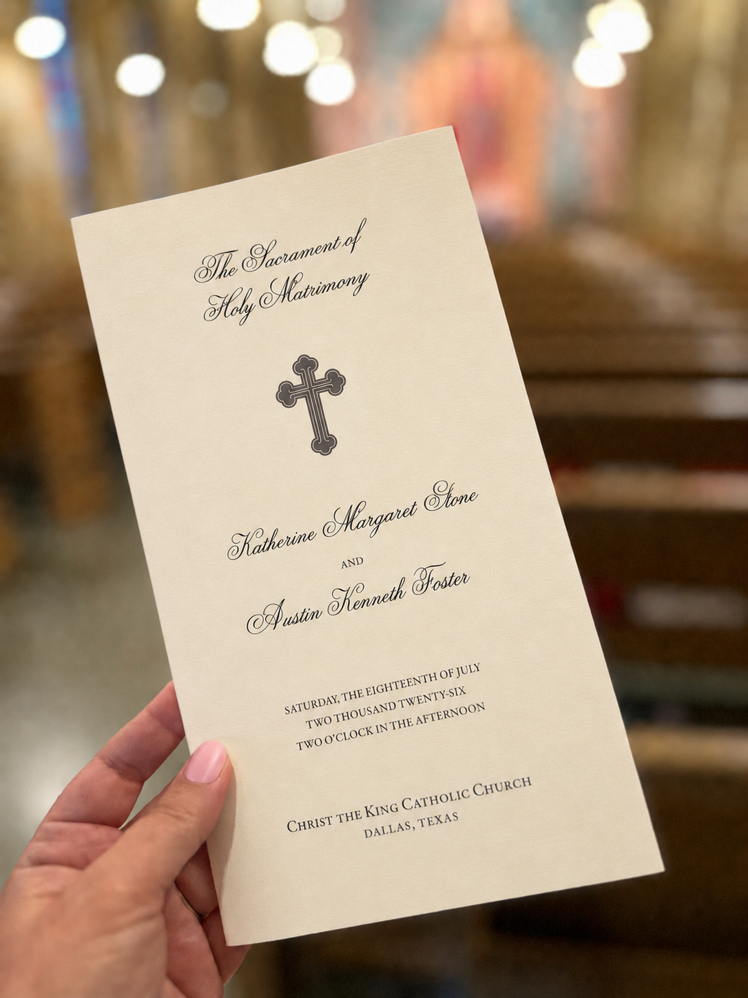 Custom Catholic wedding program displayed inside Christ the King Catholic Church