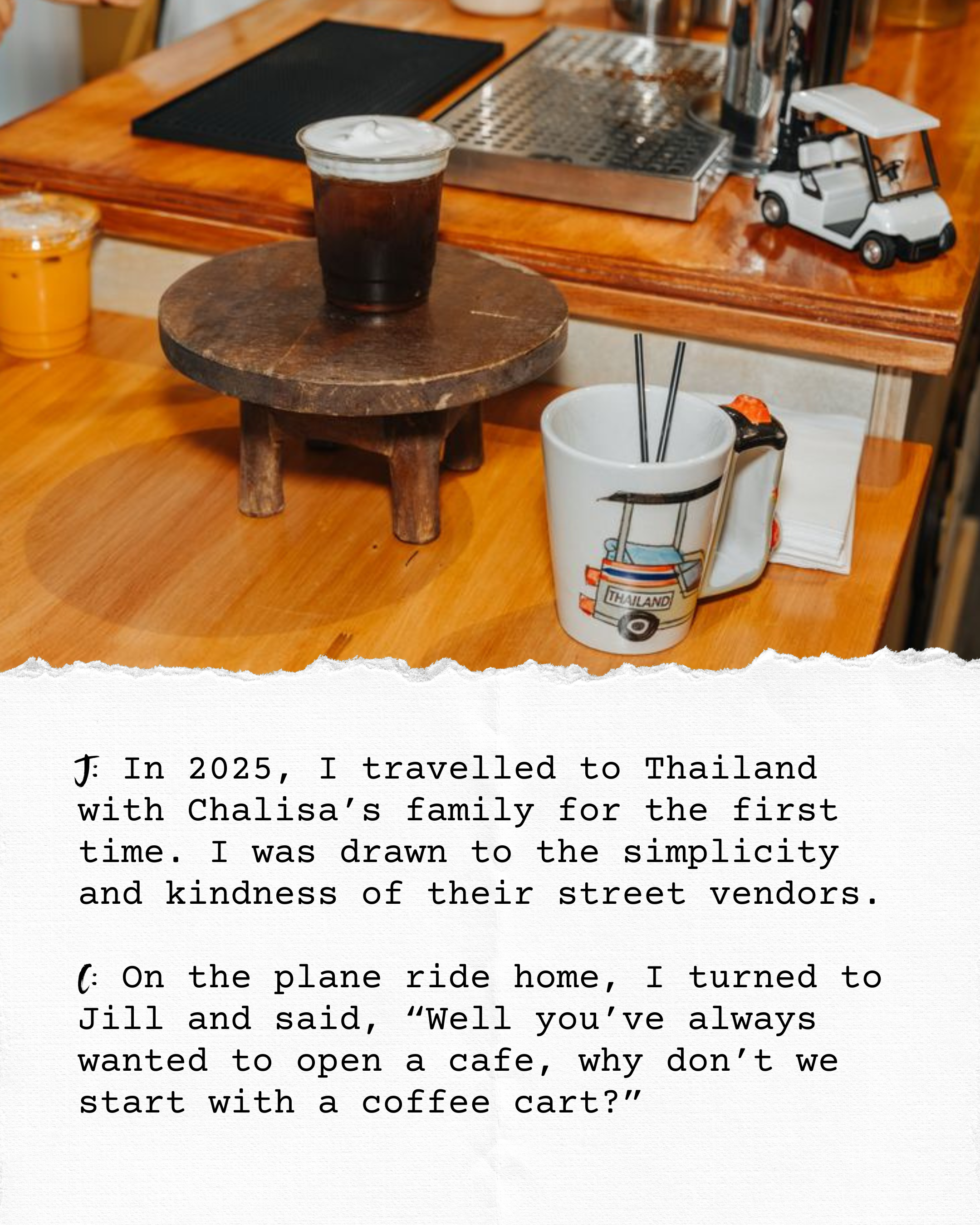 A wooden table with a small, round wooden stool. On the table, there is a glass of dark soda with ice, a white coffee mug with a colorful design of a tuk-tuk and the word 'Thailand', and a credit card.