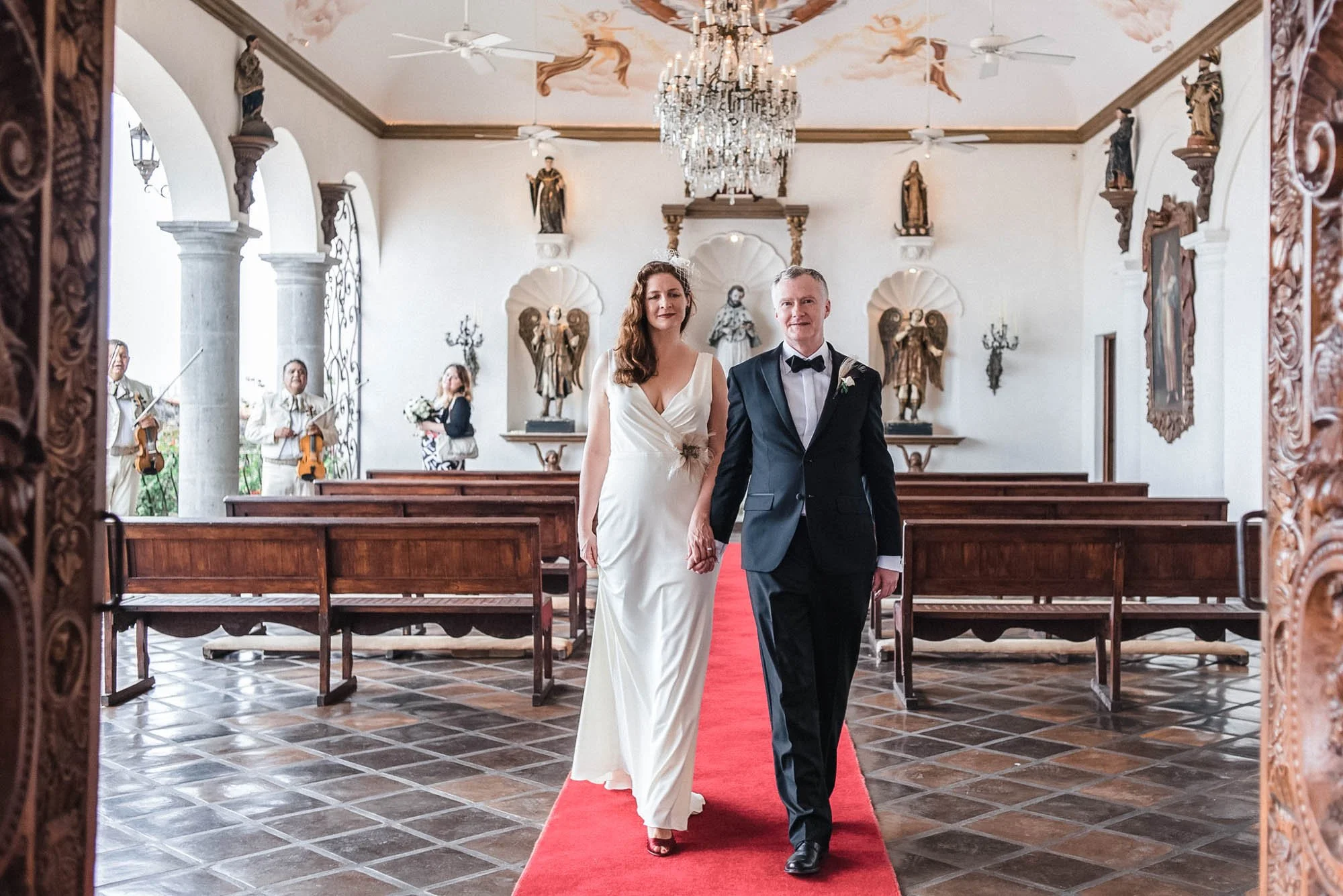 Bride and groom walking down the aisle after elopement at La Capella in Puerto Vallarta Mexico.