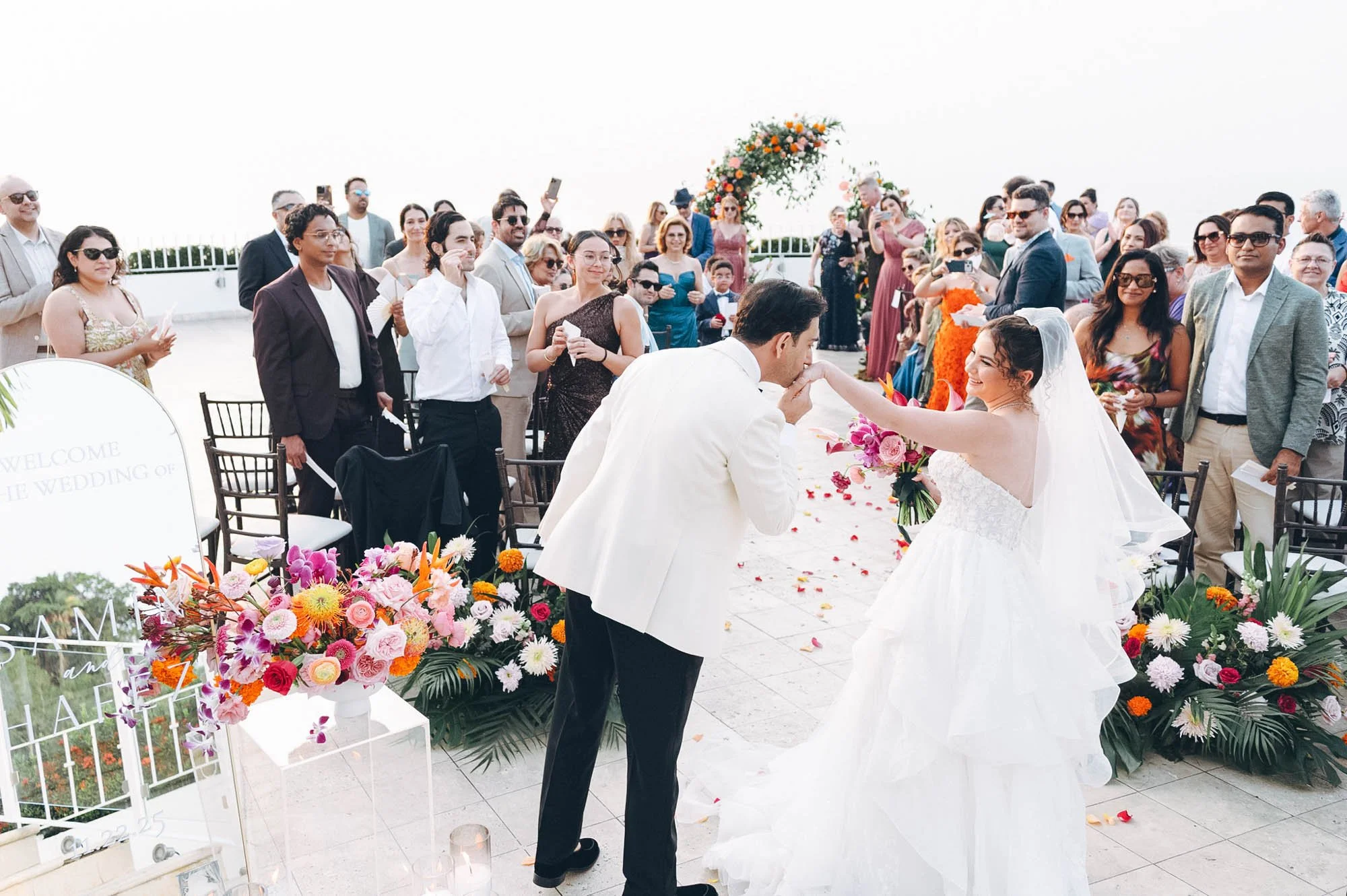 Grand Miramar rooftop Persian wedding ceremony exit groom kissing bride's hand