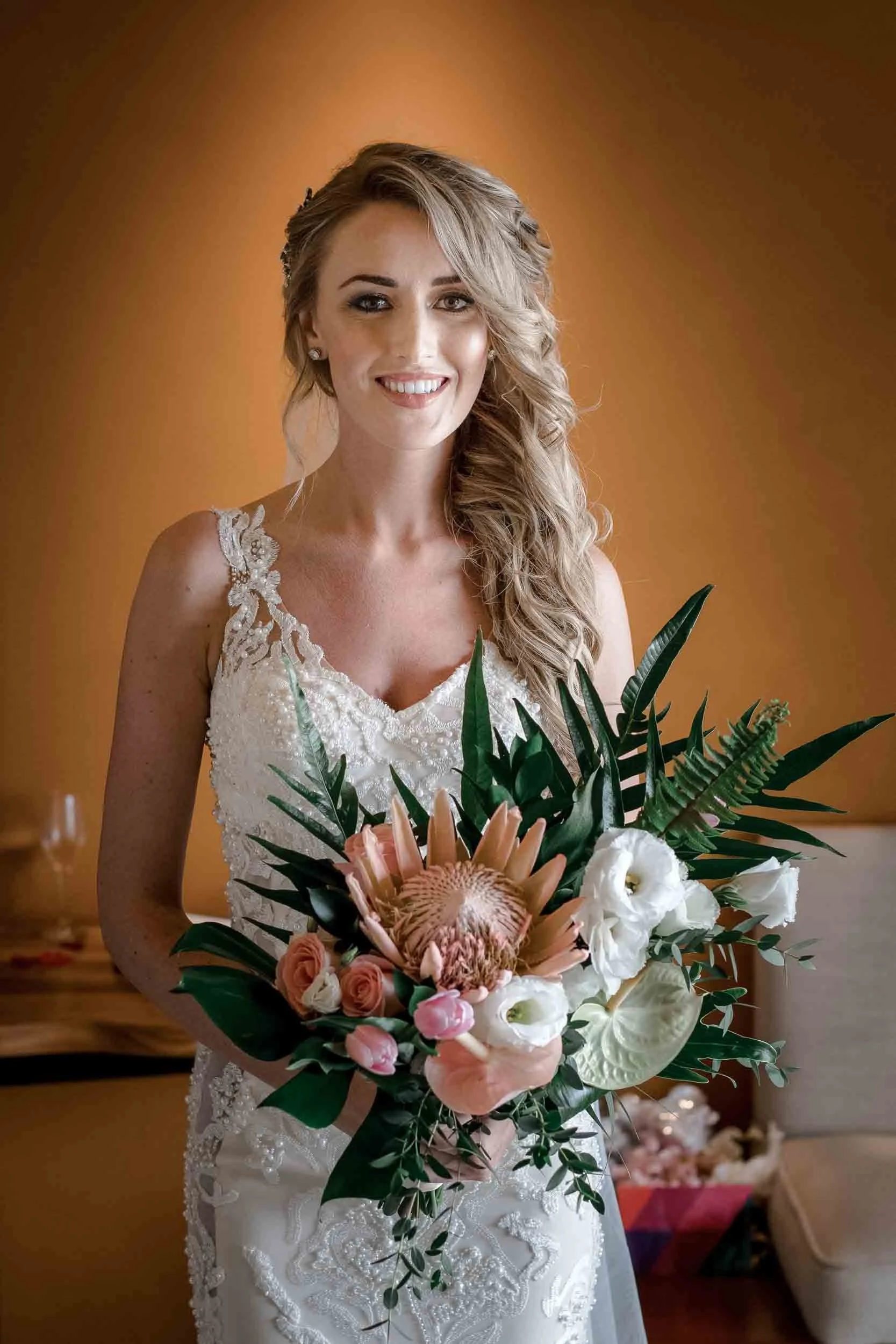A smiling bride with a warm brown background at the Hyatt Ziva in Puerto Vallarta.