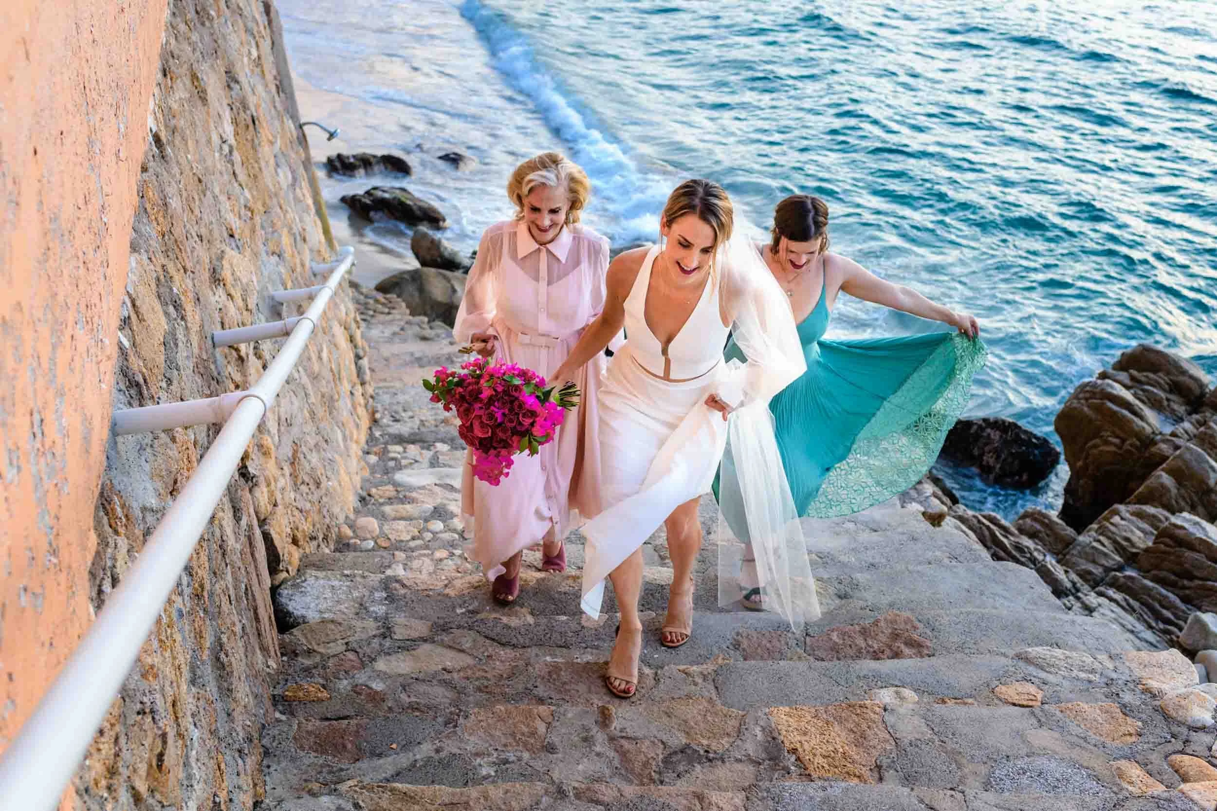 Bride, mother and maid of honor walking towards wedding ceremony.