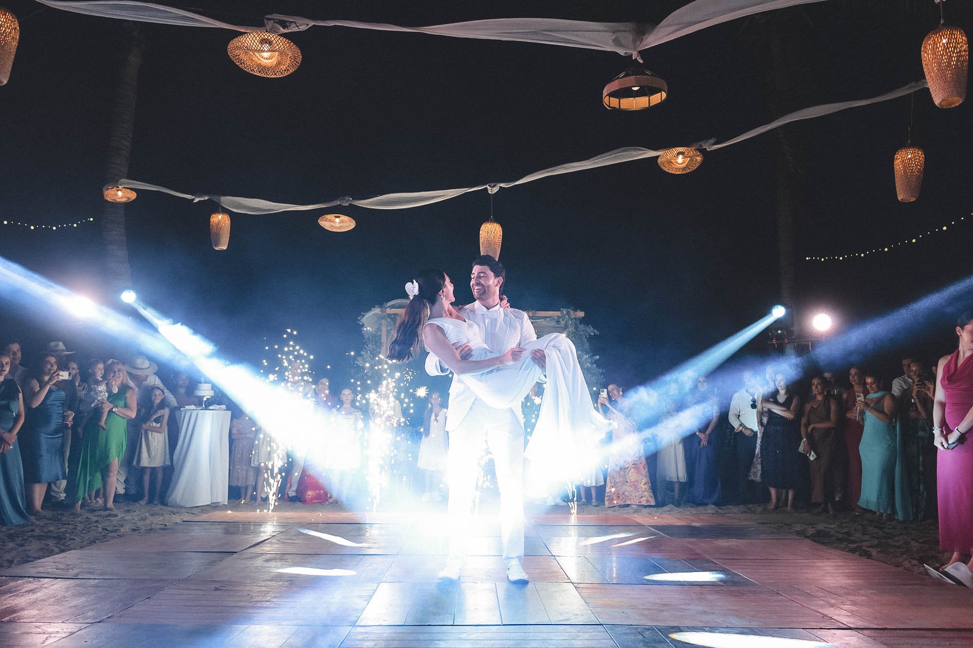 First dance bride and groom with light show on the dance floor.