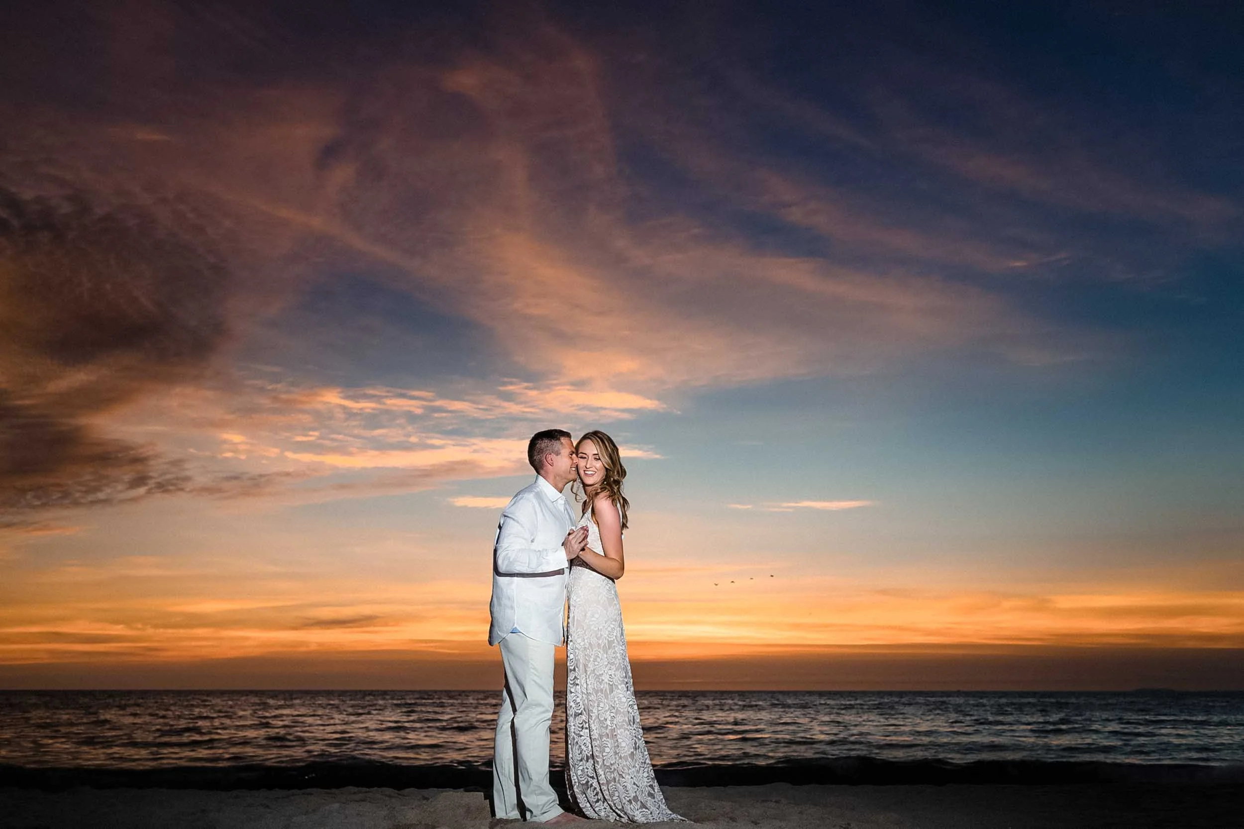 Sunset backdrop with engaged couple at the Hyatt Ziva beach
