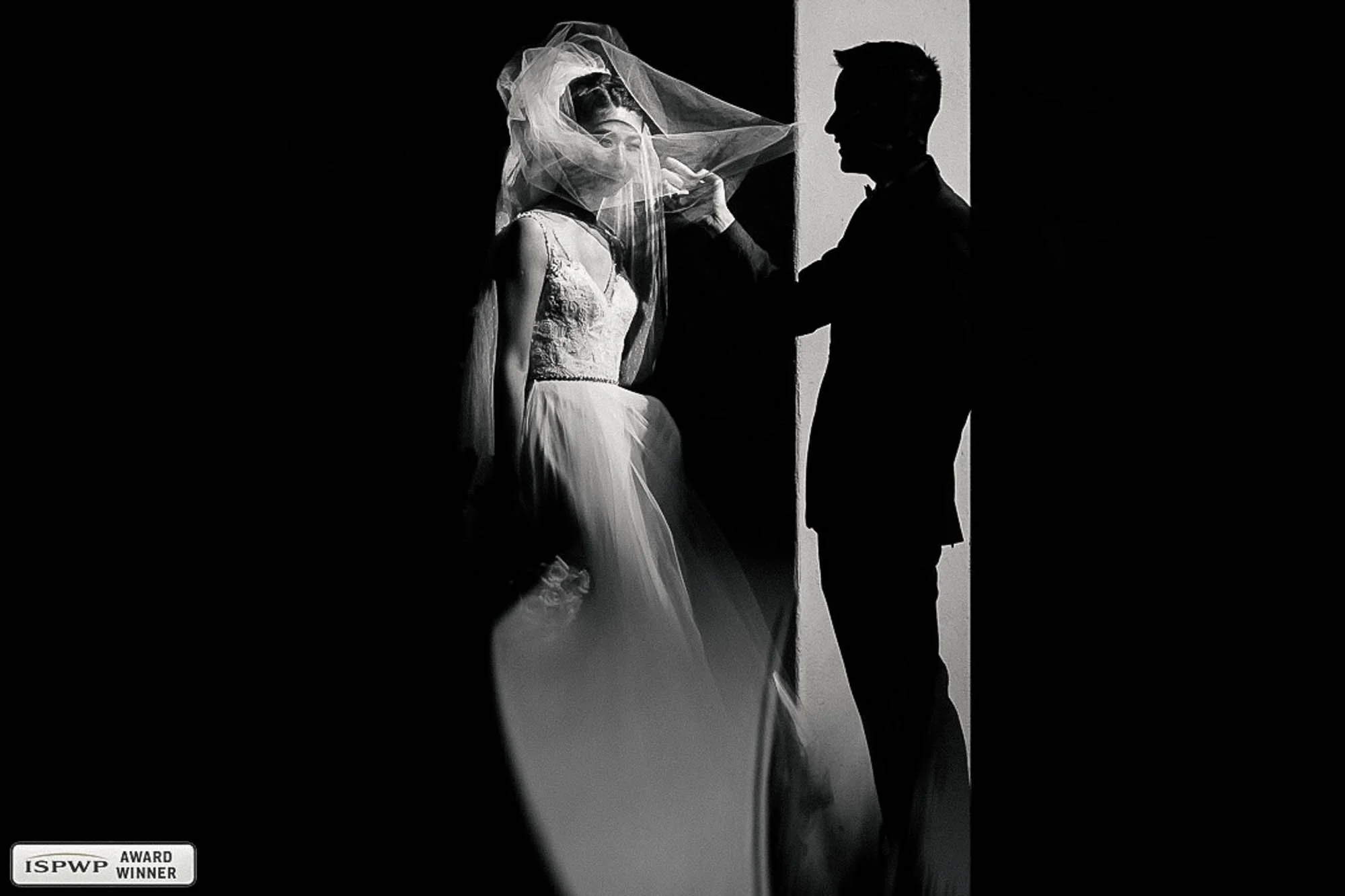 Modern portrait of bride and groom with a twist of light and shadows. 