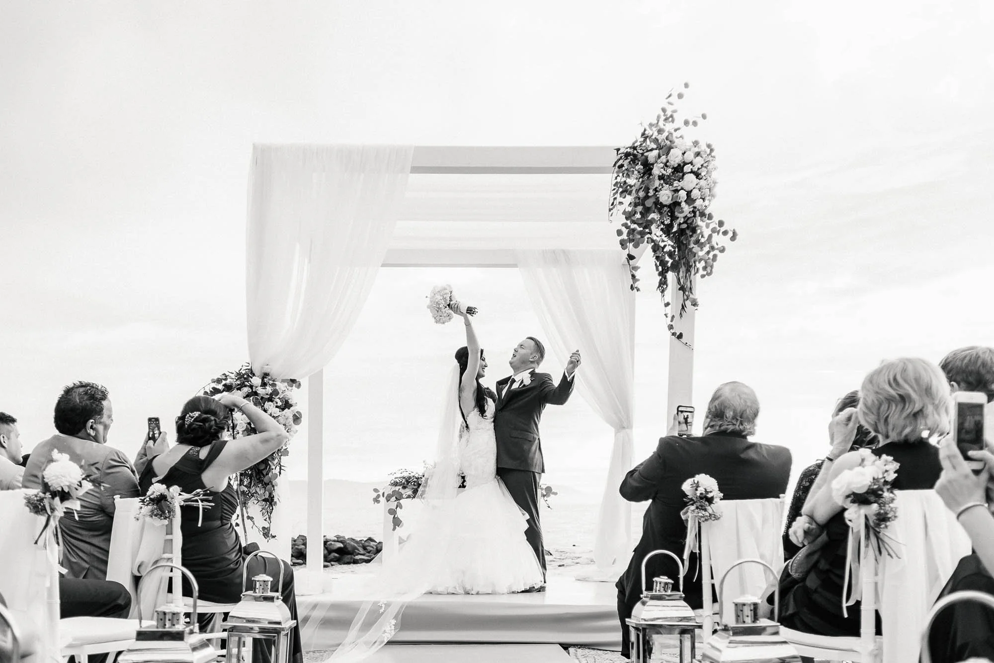 Wedding ceremony at the Westin with bride and groom cheering up in the air.