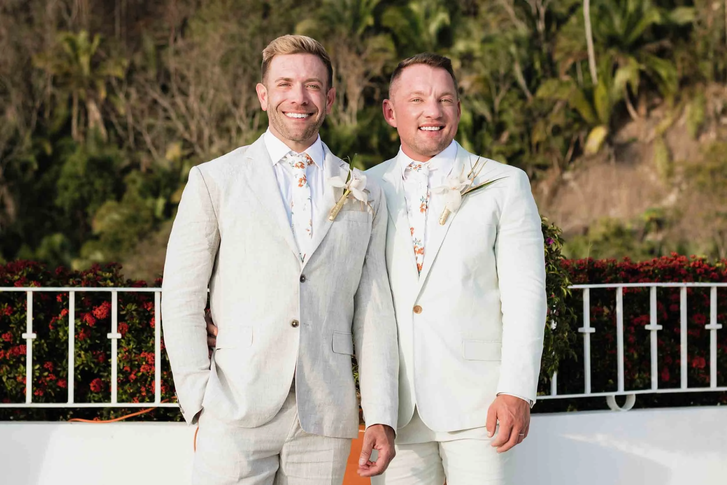 Grooms posing for a portrait photo at their wedding celebration.