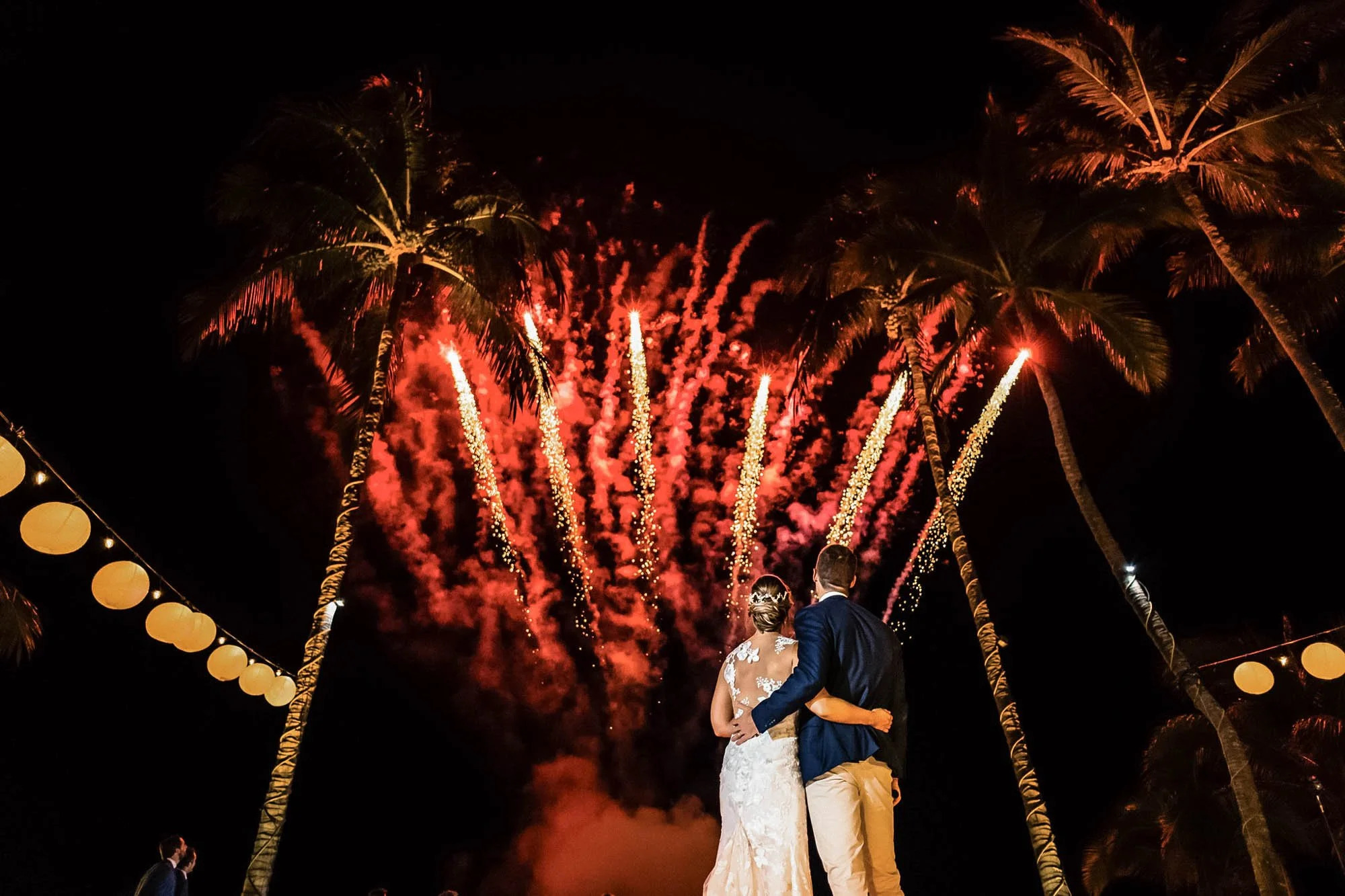 Wedding fireworks with bride and groom looking up from the dance floor.