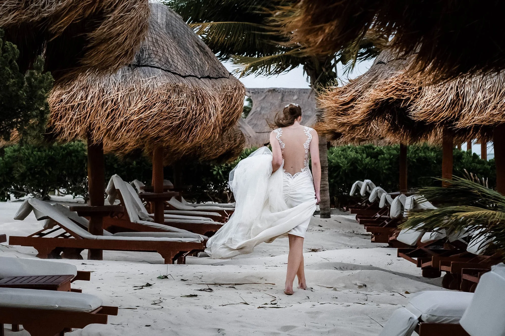 Bride walking at the beach of her destination wedding in Mexico