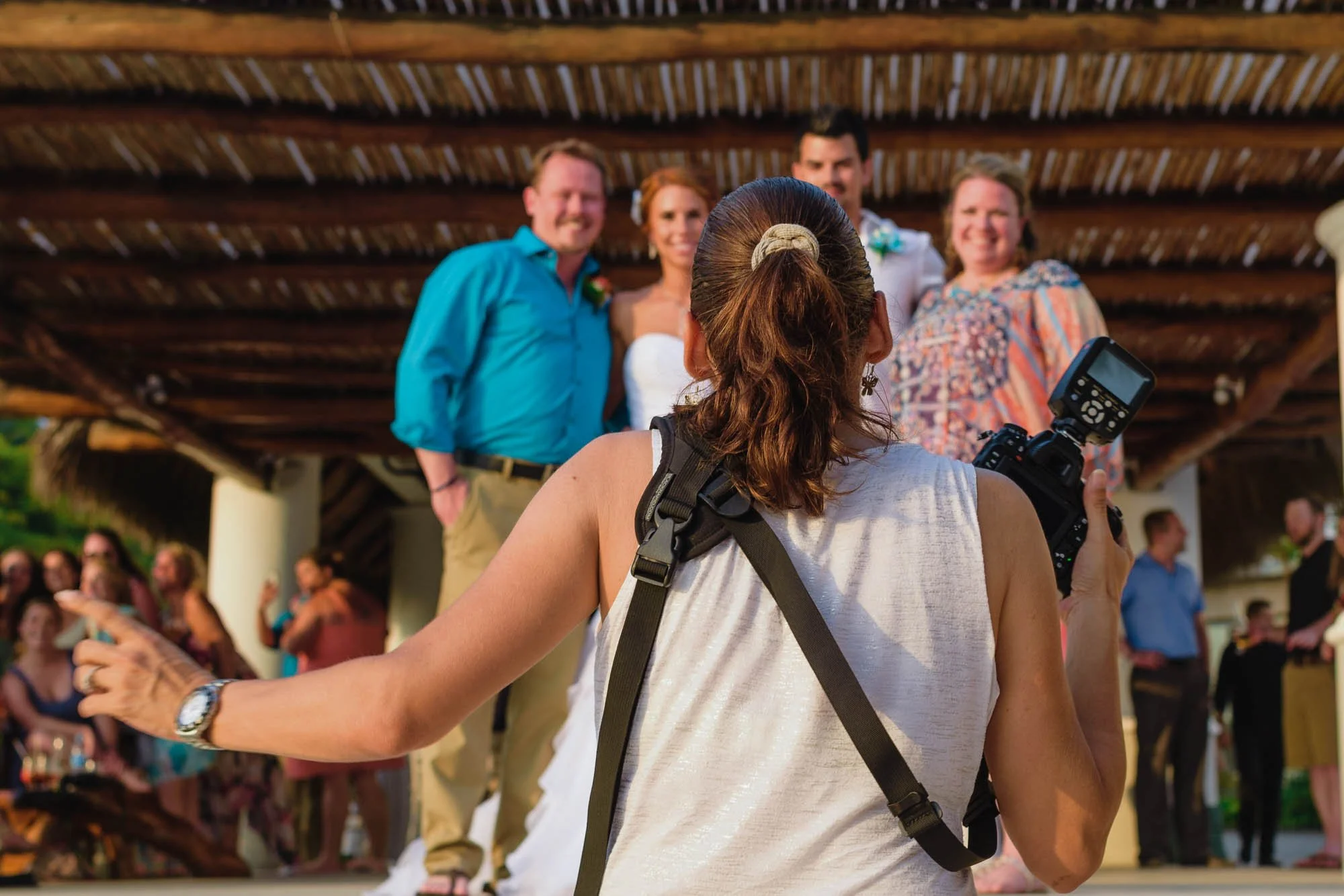 Wedding photographer giving directions on portrait to family