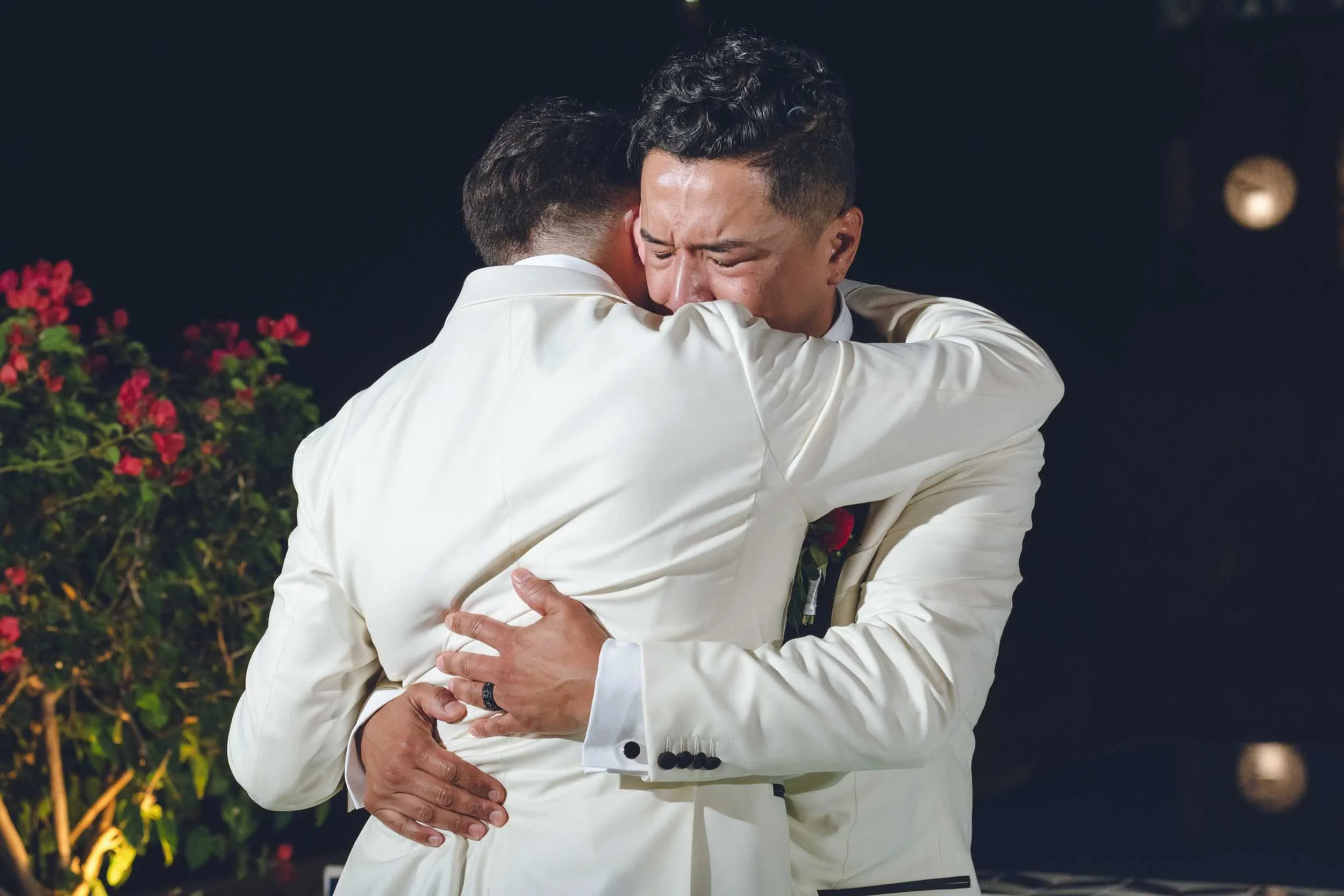 Emotional hug of gay grooms during their first dance on their wedding day at La Cappella in Puerto Vallarta.