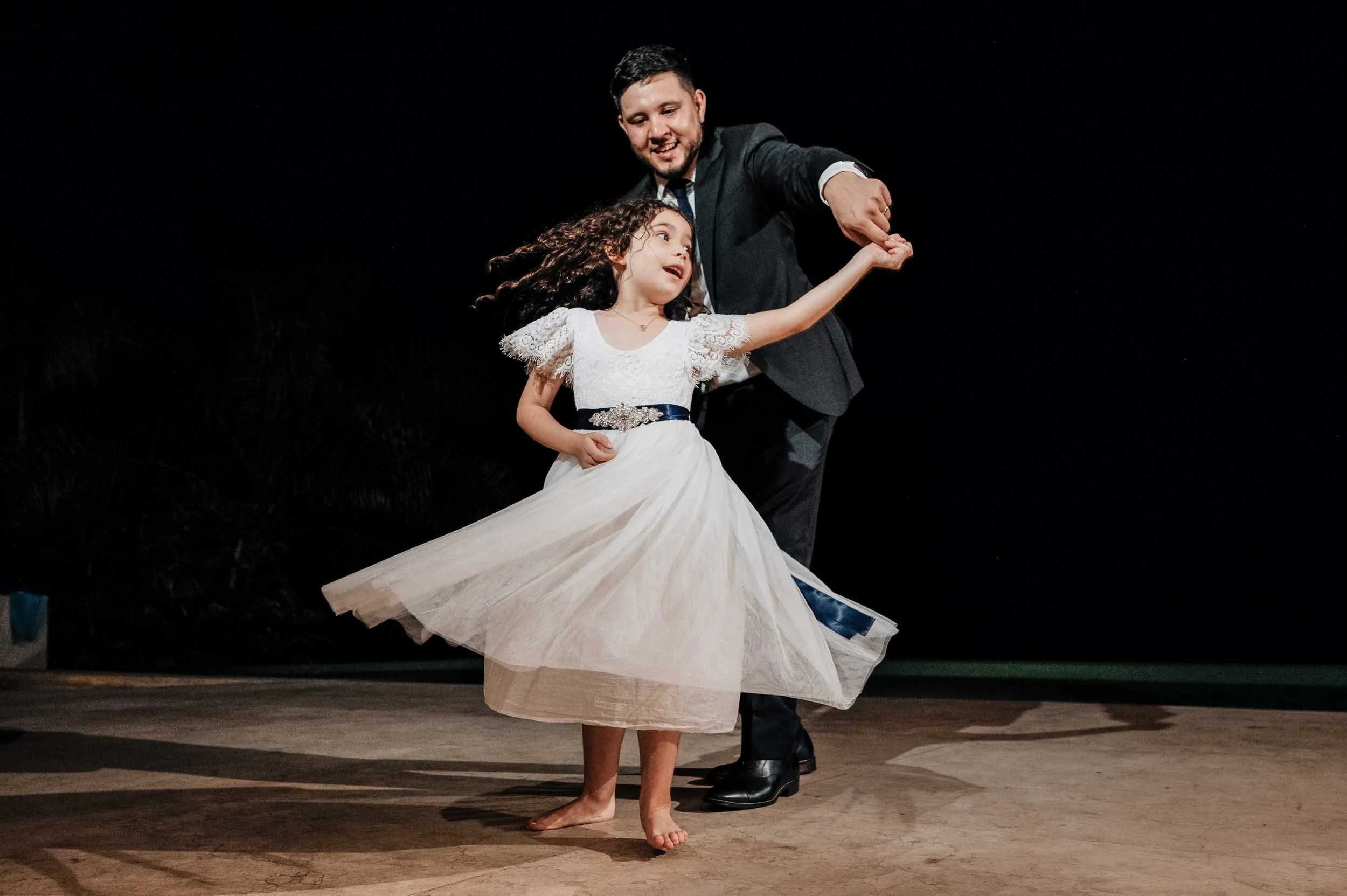Groom dancing with flower girl at villa wedding in Puerto Vallarta