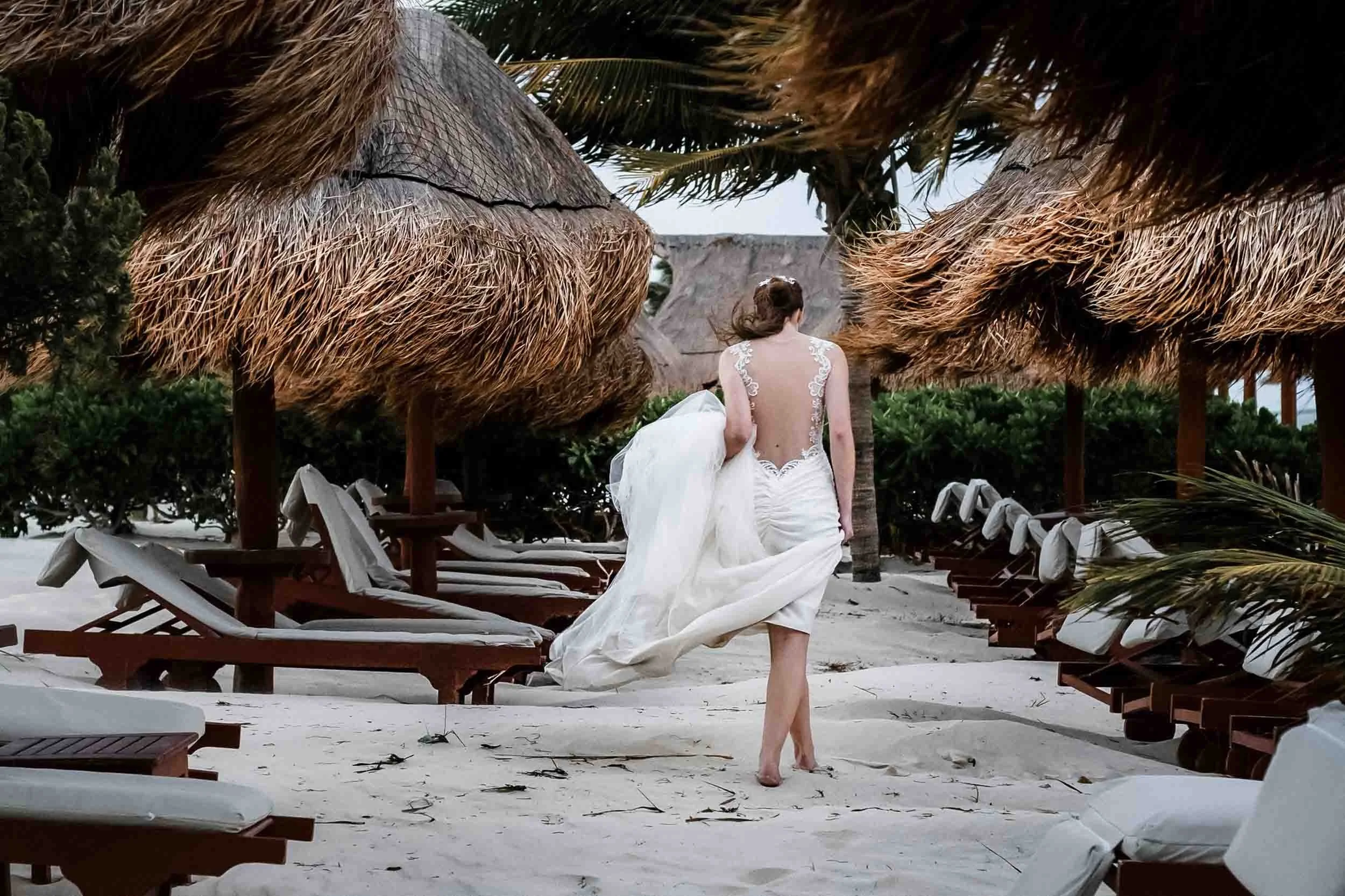Bride walking at the beach of her destination wedding in Mexico