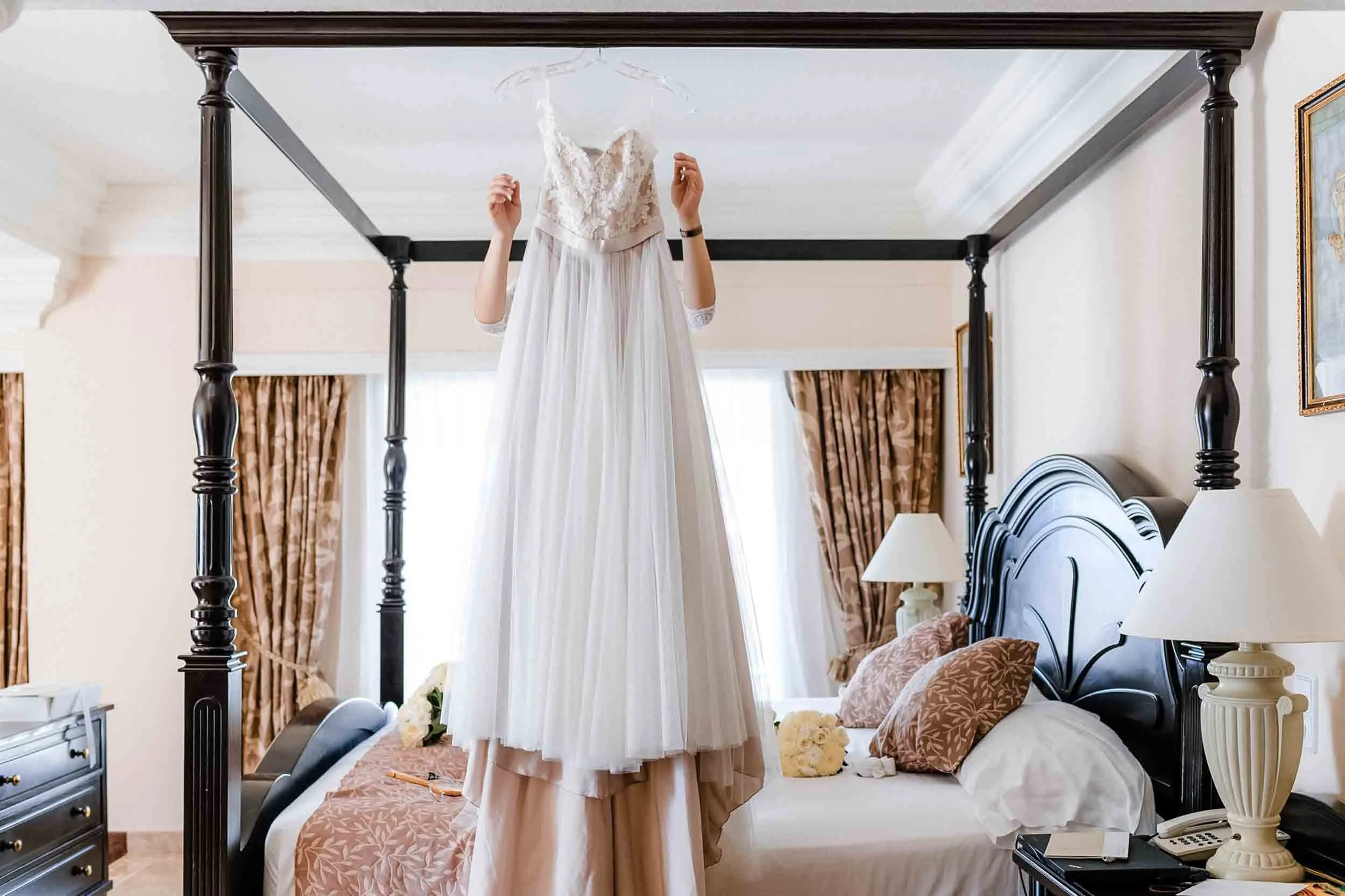 Bride hanging beach wedding dress in Vallarta