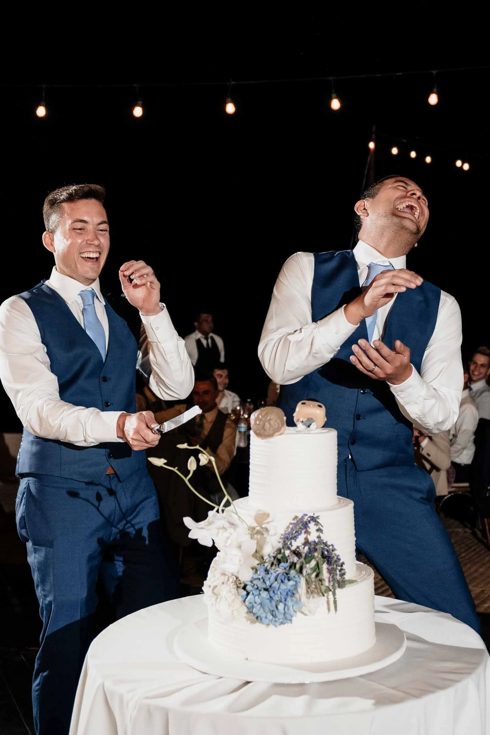 Cake cutting by happy grooms during their wedding reception at a luxury private villa in Puerto Vallarta