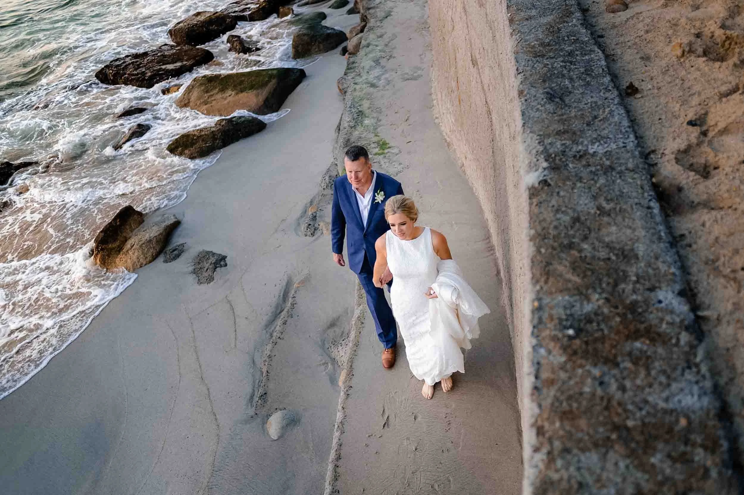 Bride and groom walking on beach at villa wedding in Puerto Vallarta