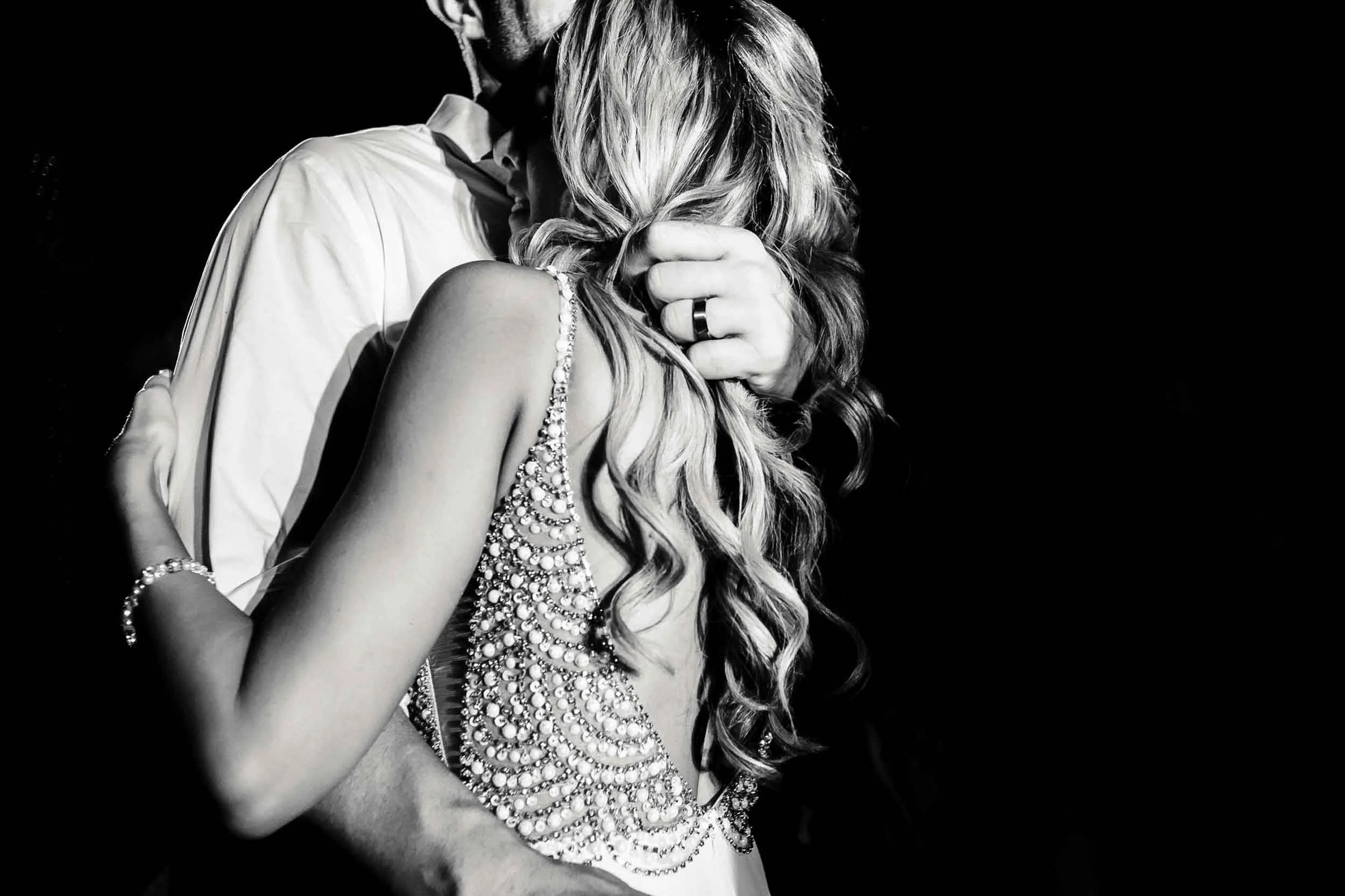 A black and white photo bride and groom during the last dance of their wedding party. 