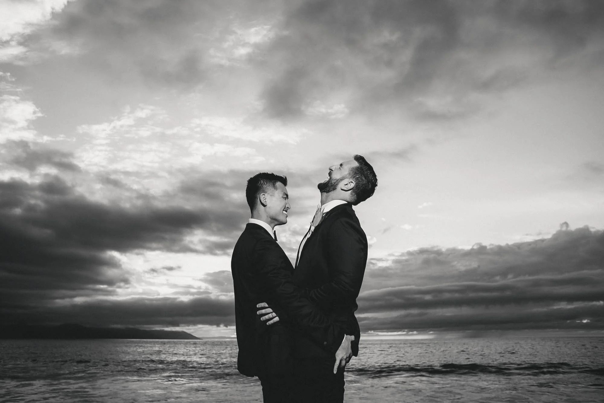 Happy gay grooms at the Hyatt Ziva Puerto Vallarta beach on their wedding day.