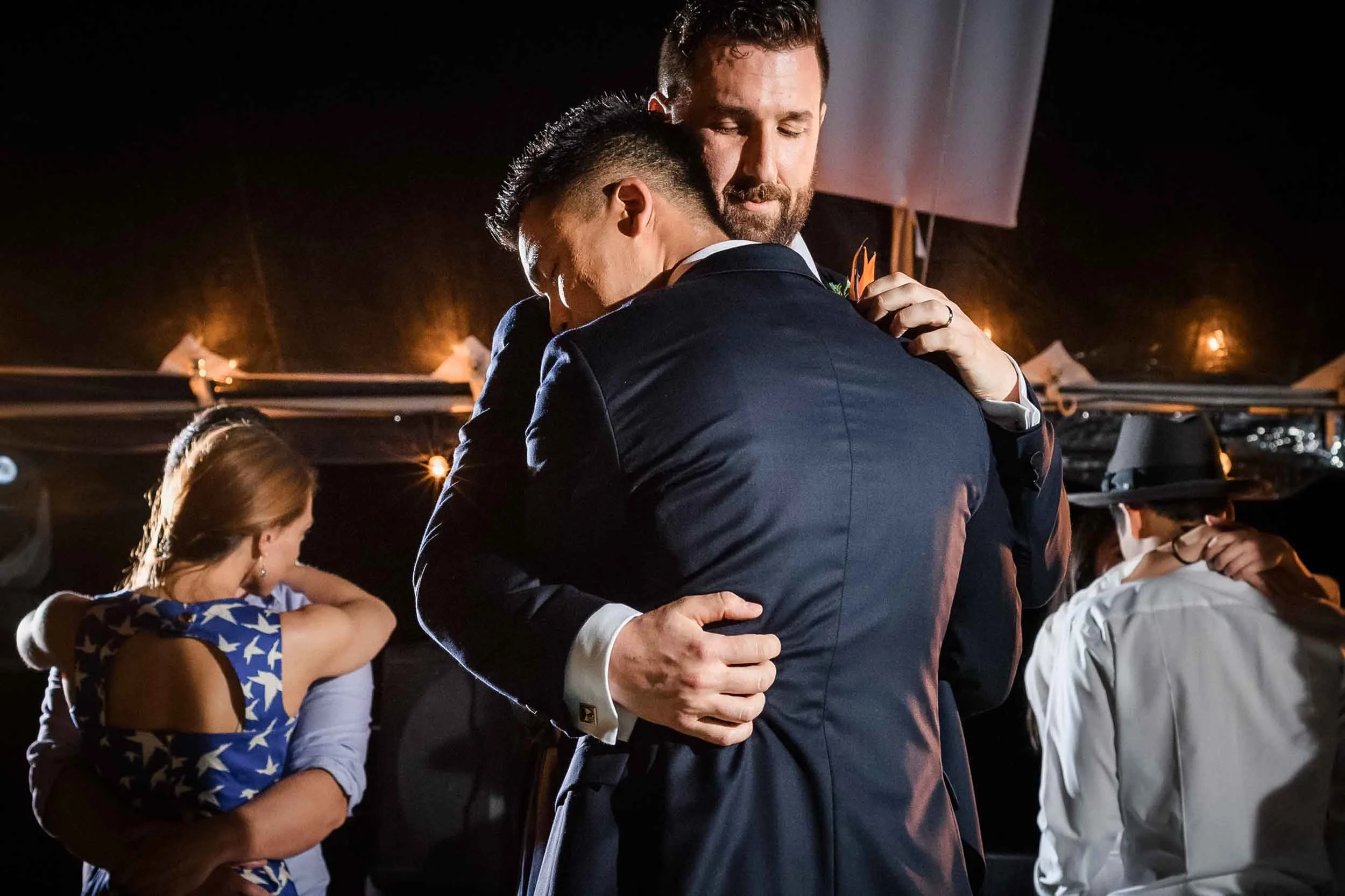 Grooms hugging each other during their first dance as husbands. 