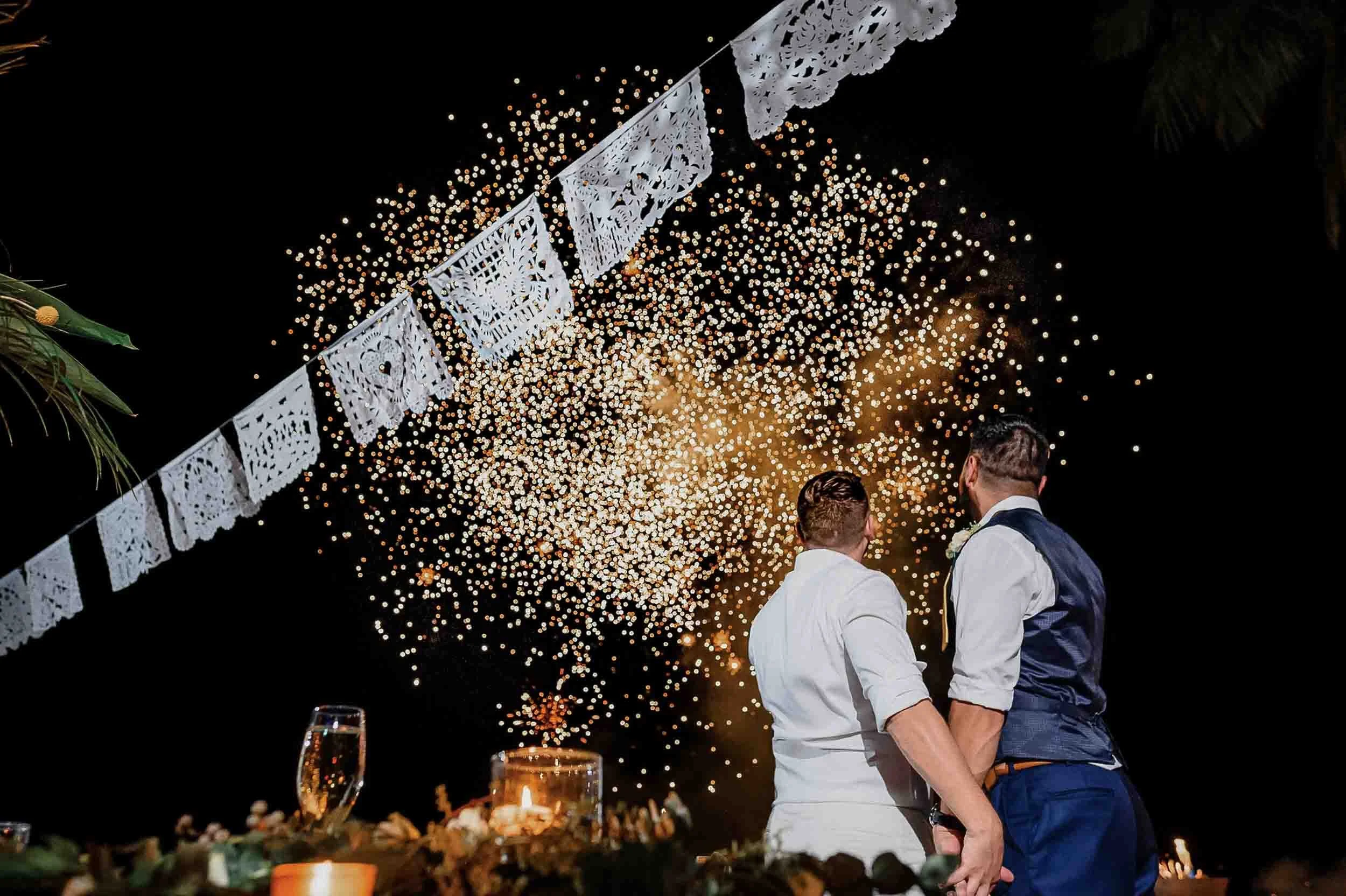Beautiful fireworks at the end of the first dance of a gay couple on their destination wedding at the beach in Puerto Vallarta