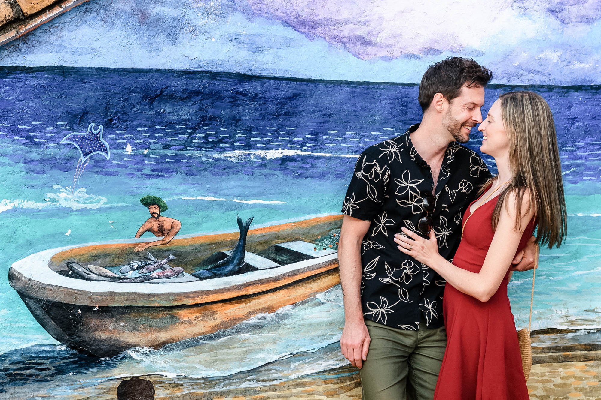 Couple posing with a mural in the background in downtown Puerto Vallarta. 
