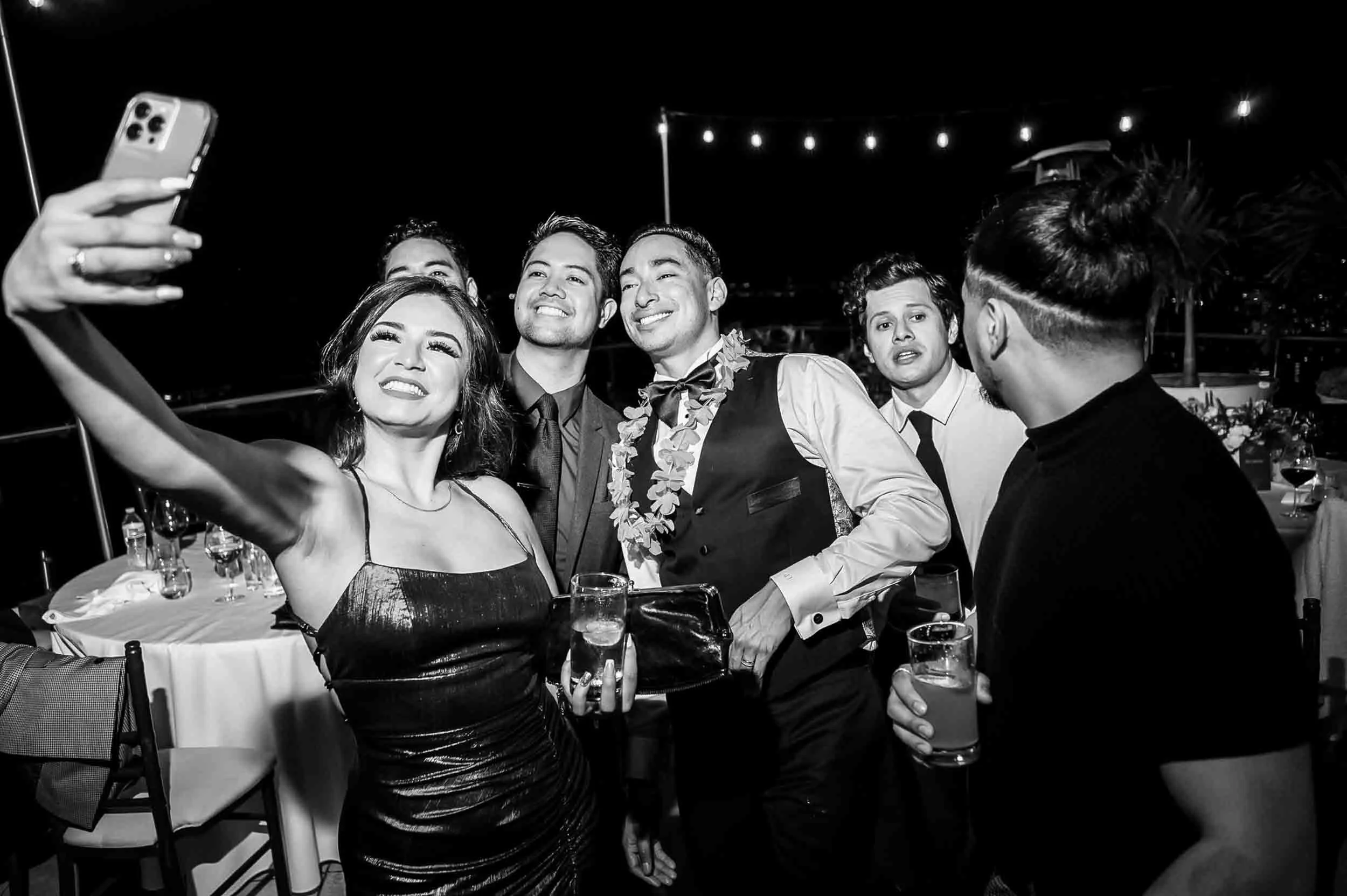 Group of groom and friends taking a selfie together during the wedding reception. 