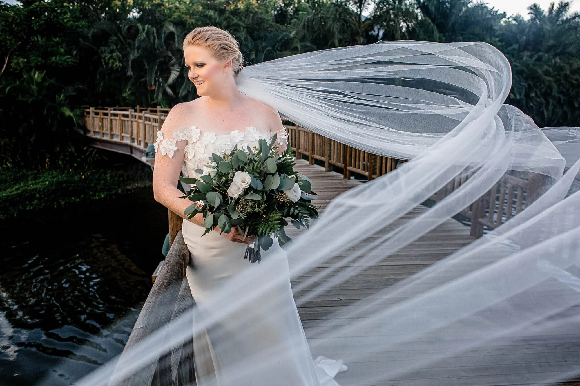 Bride portrait with veil flying with the wind. 