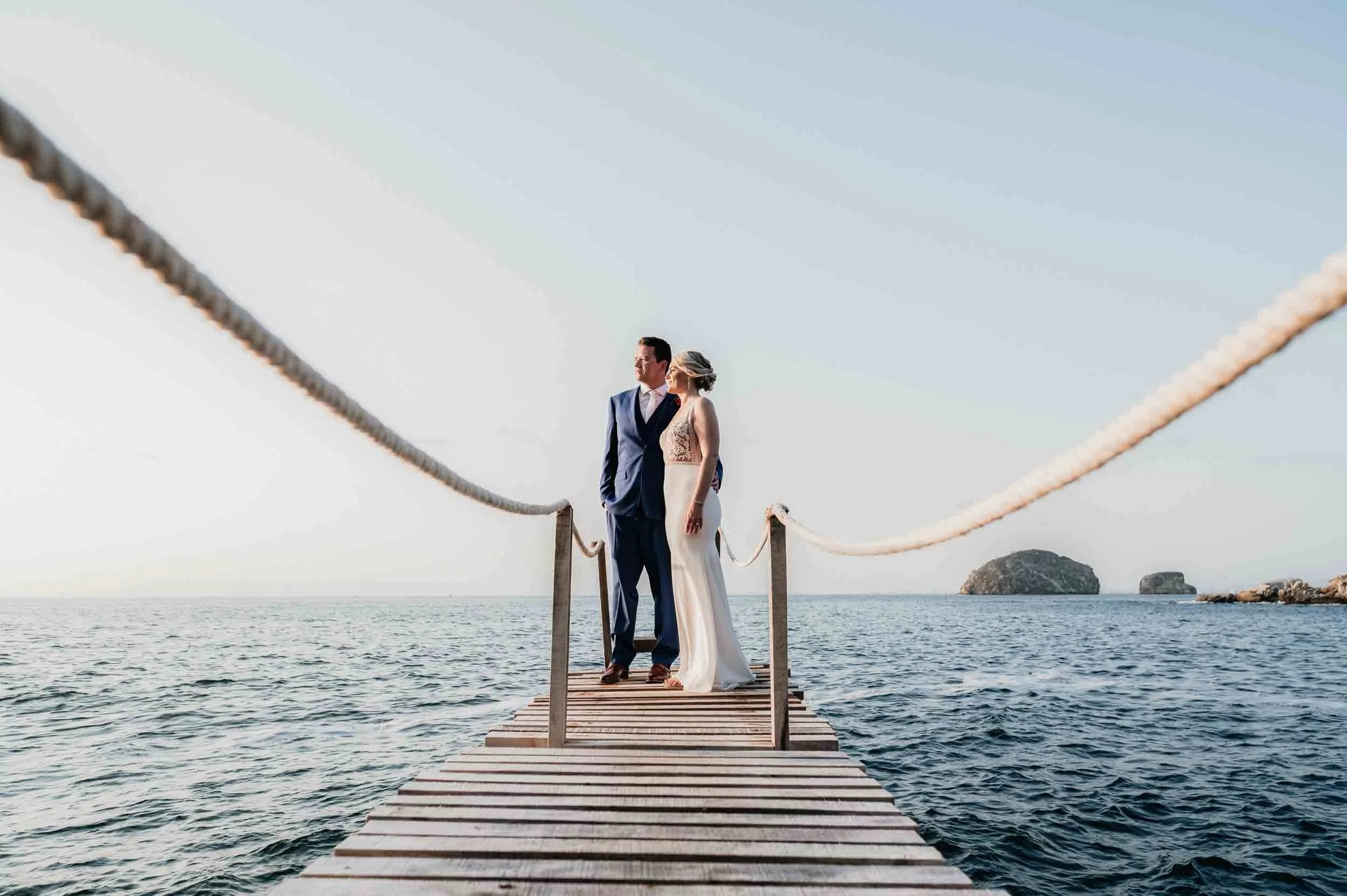 Bride and groom posing at private villa dock in Puerto Vallarta