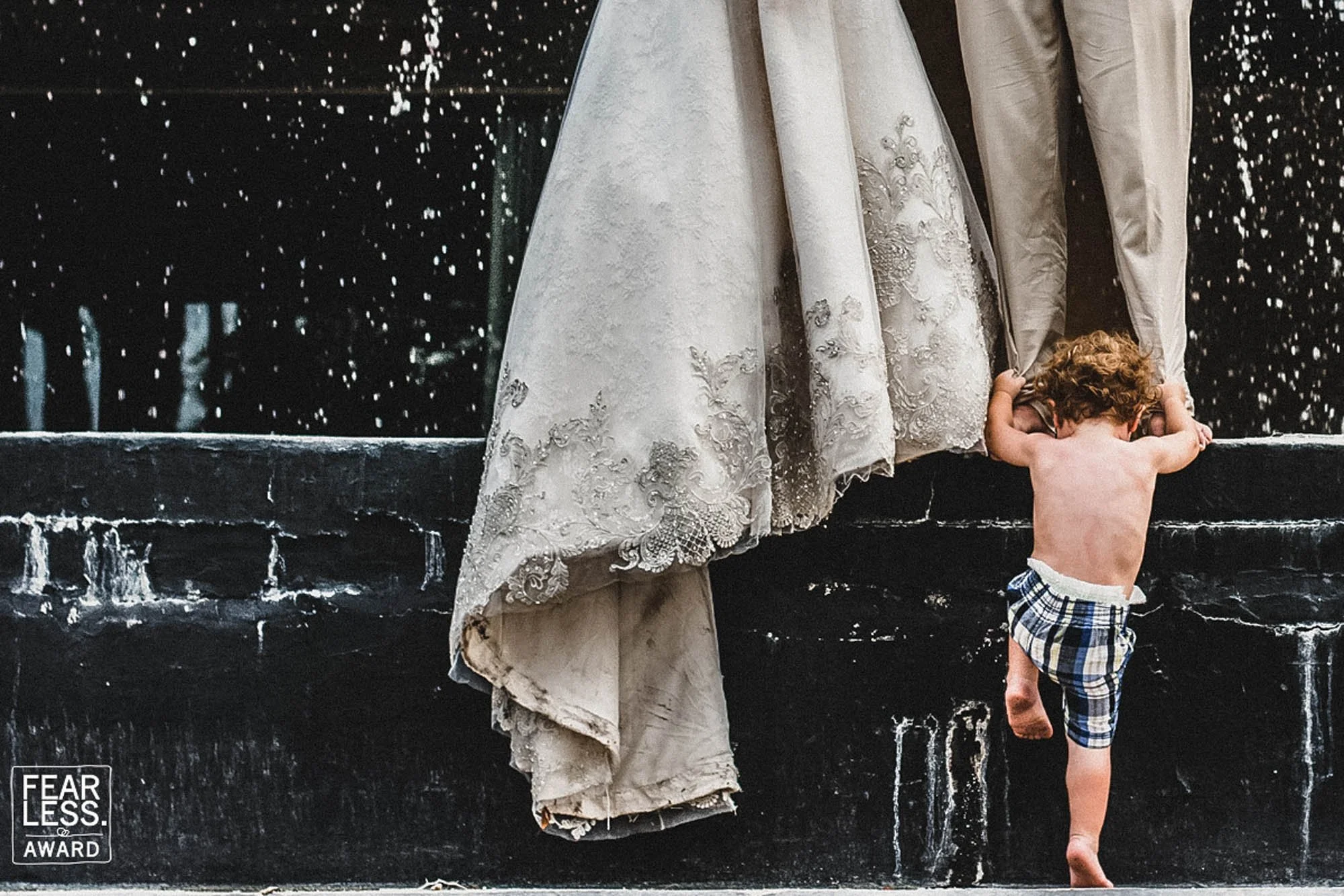 child climbing aside wedding dress train