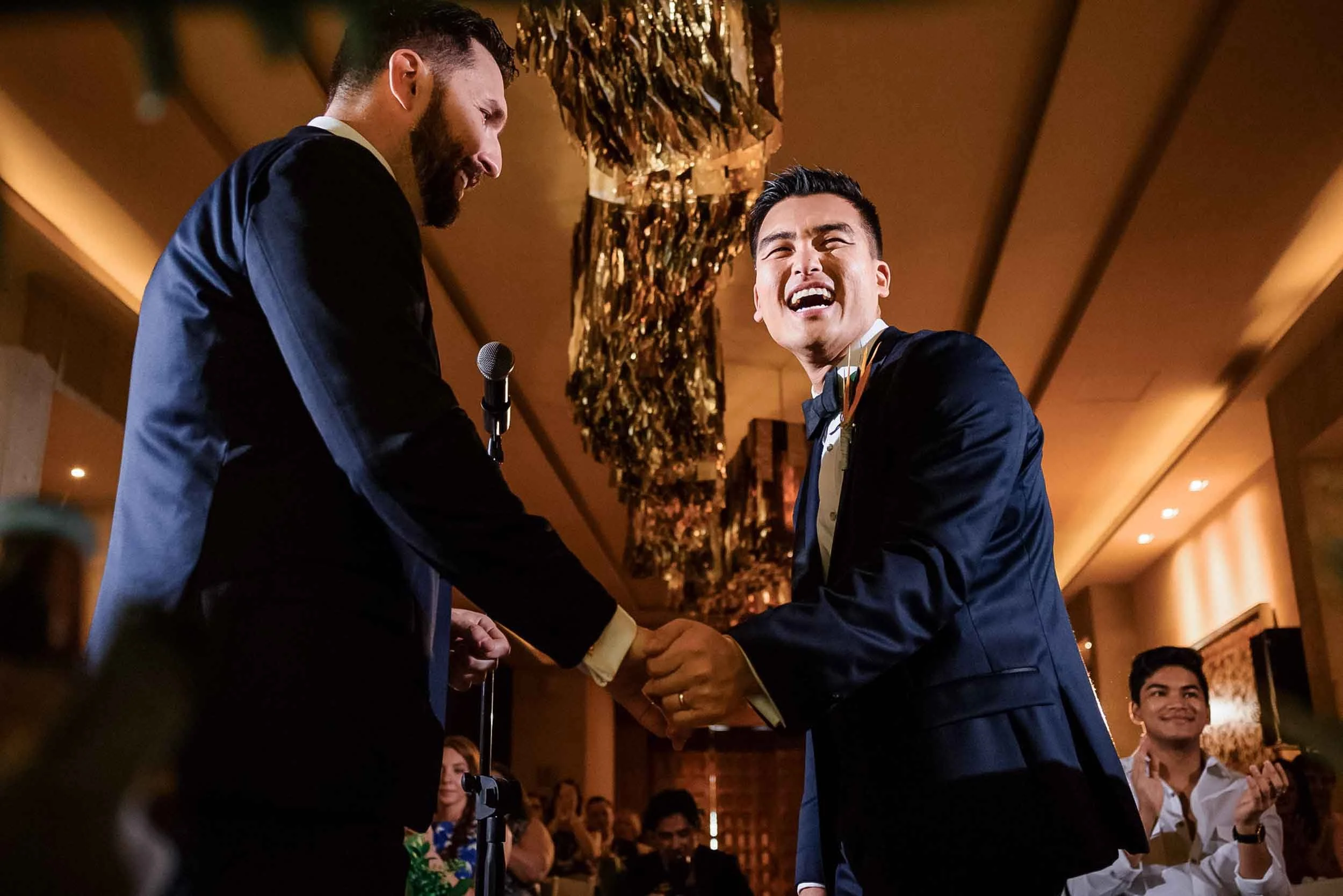 Happy grooms during their wedding ceremony exchanging vows.