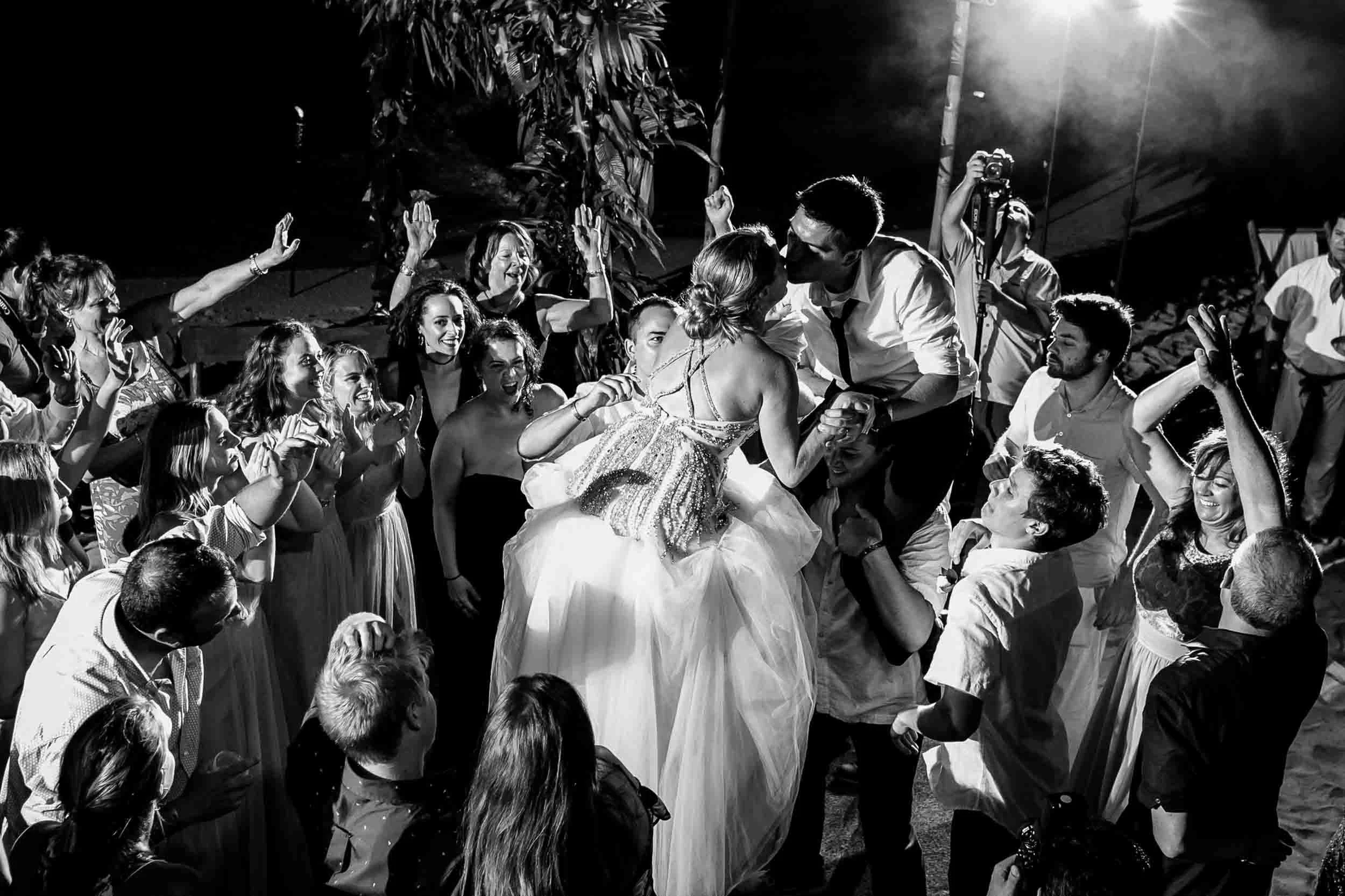 Bride and groom kissing on the dance floor during the reception of their beach wedding in Puerto Vallarta