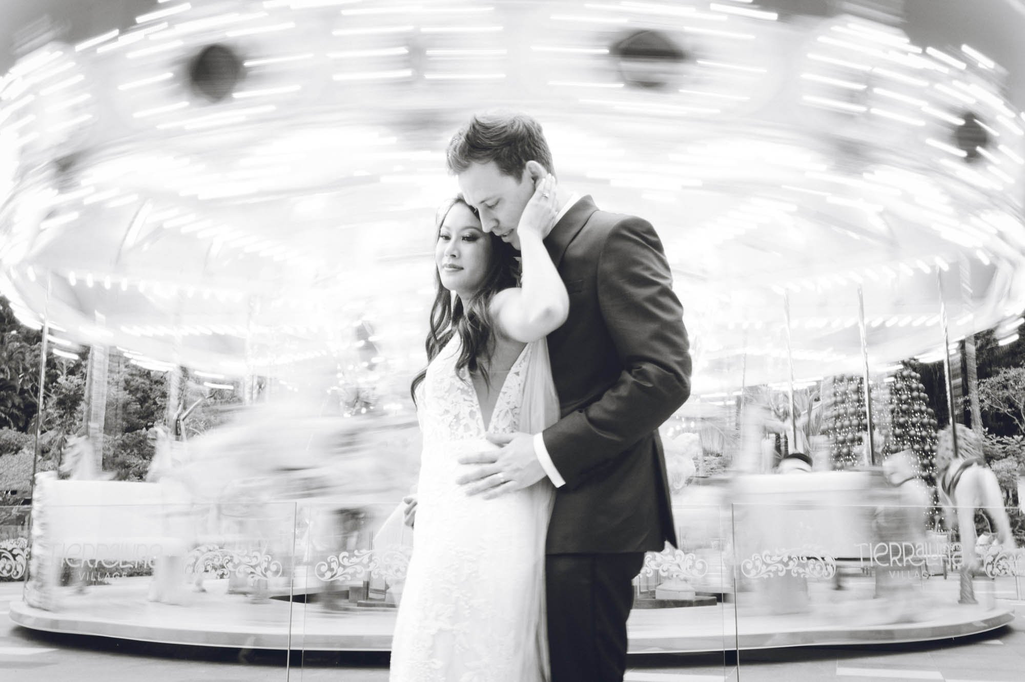 Bridal portrait with motion blur of a carousel in the background.