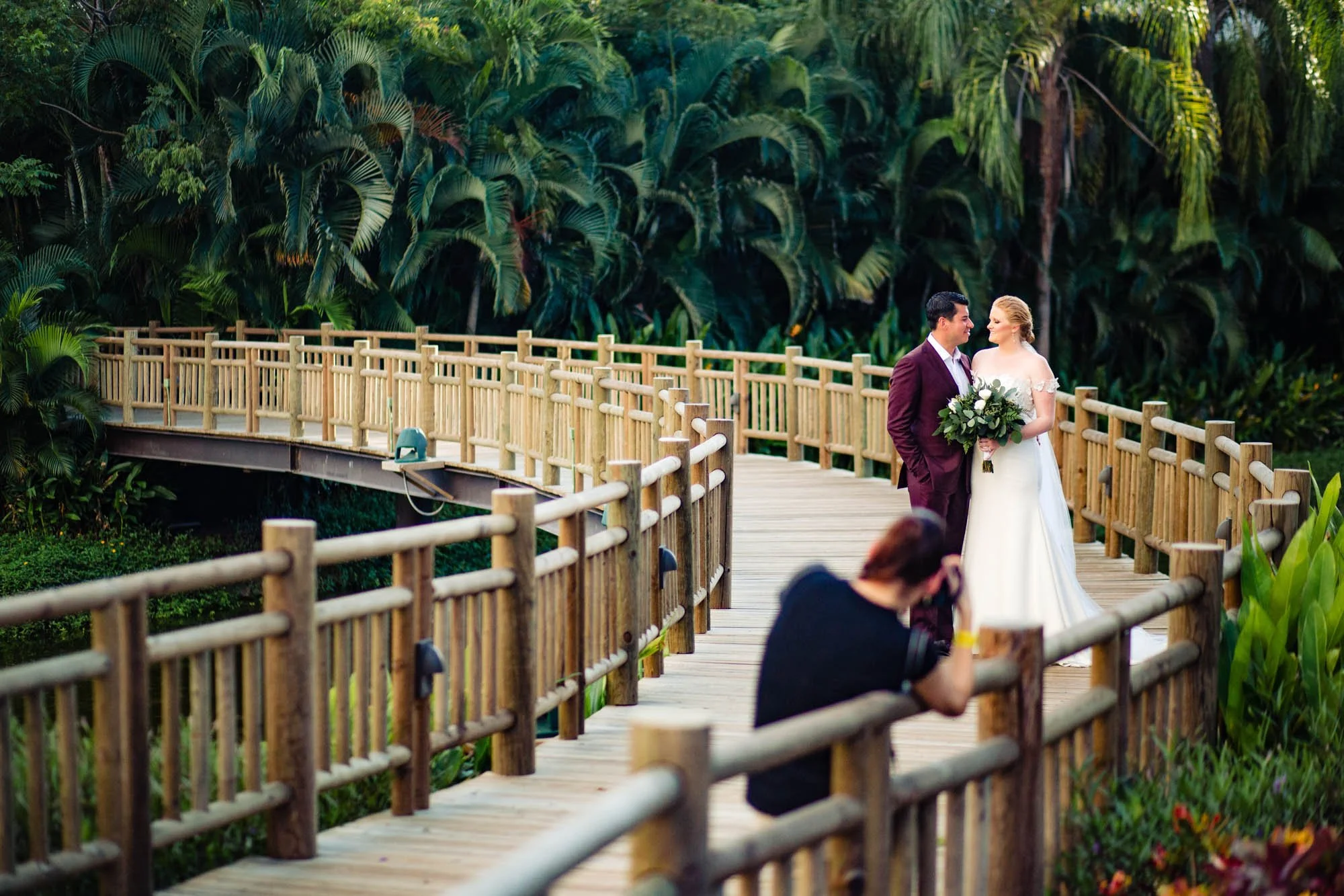 Newlyweds having their photo taken by professional photographer on wedding day
