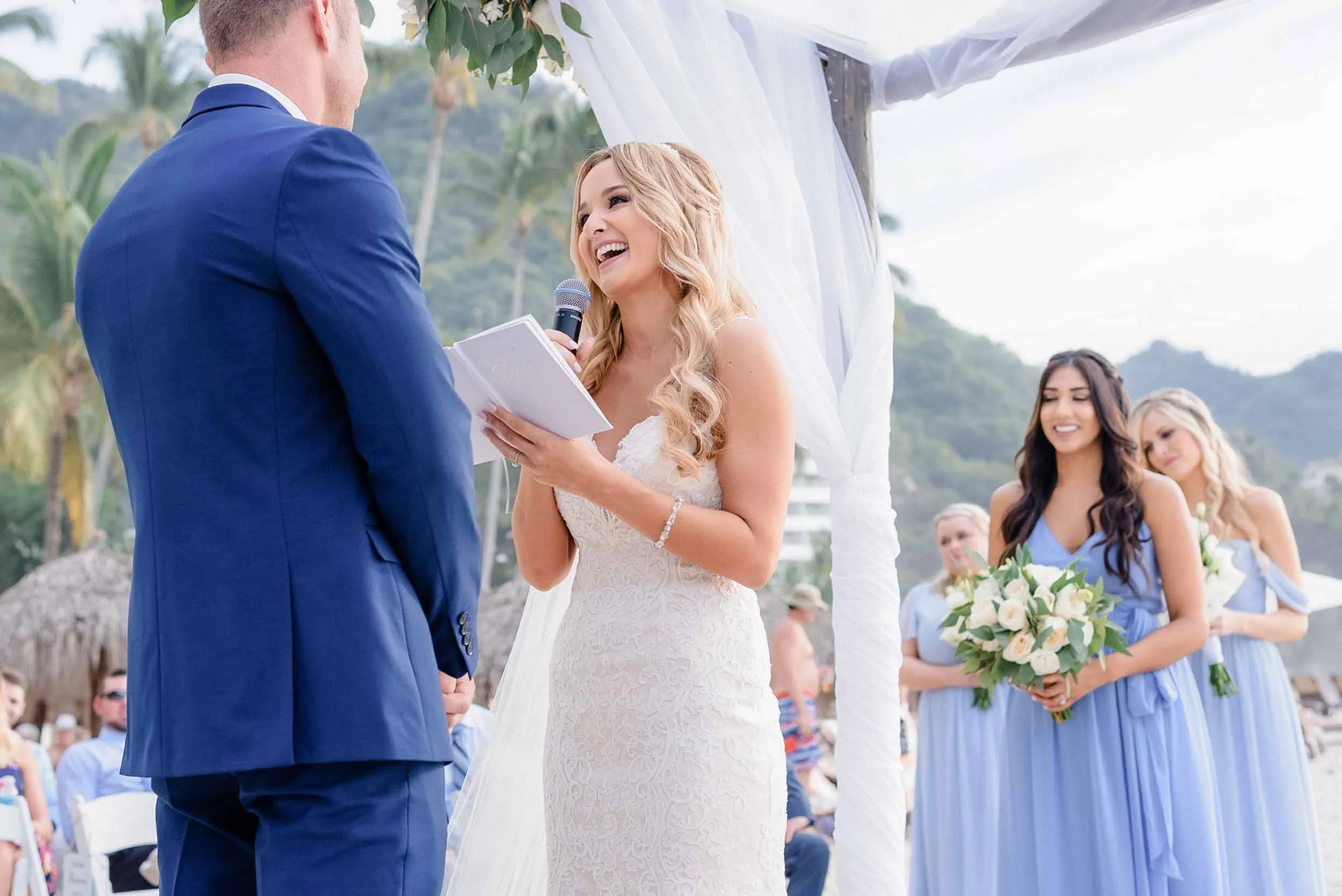Bride and groom exchange vows during their beach wedding ceremony.