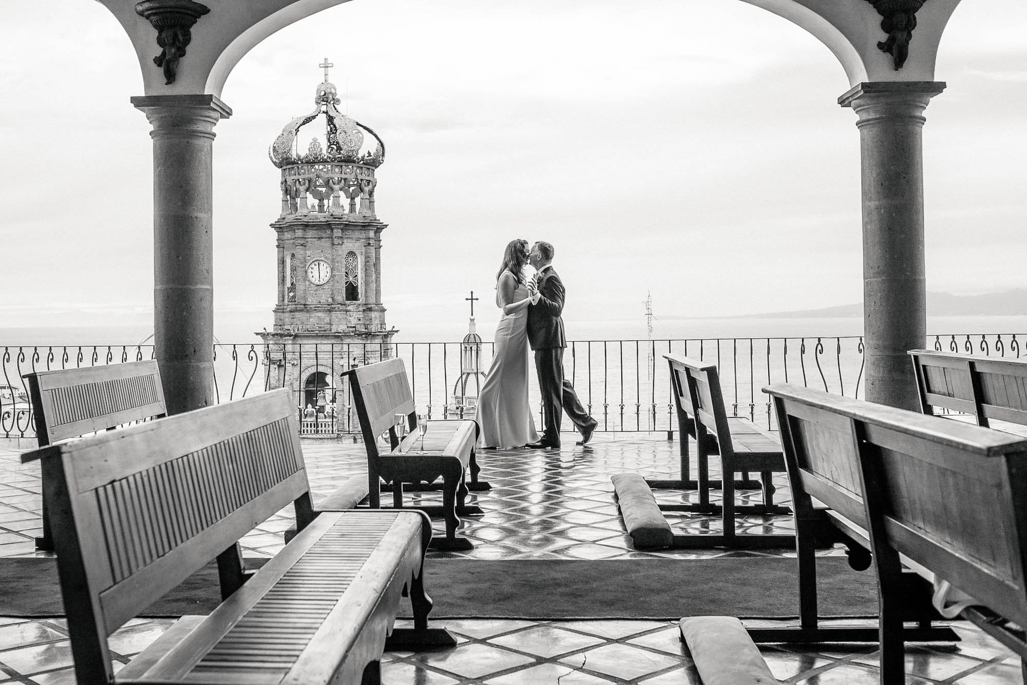 La Capella with church backdrop and newlyweds dancing  in downtown Puerto Vallarta