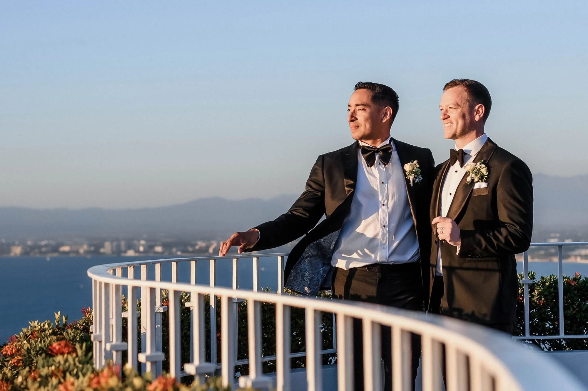 Gay couple posing for wedding portrait during sunset on a rooftop of the Grand Miramar.