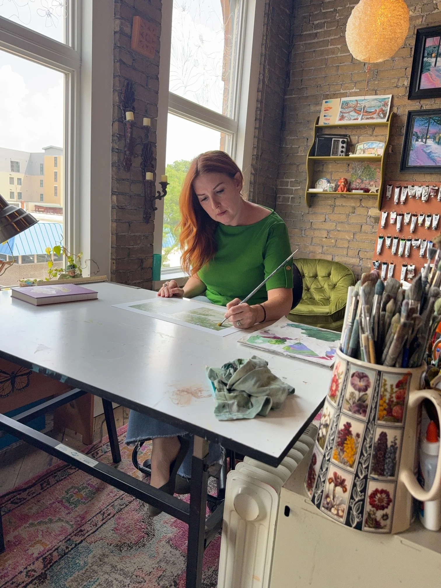 Colleen Drew, muralist and fine artist, hand-painting in her Oconomowoc, WI studio