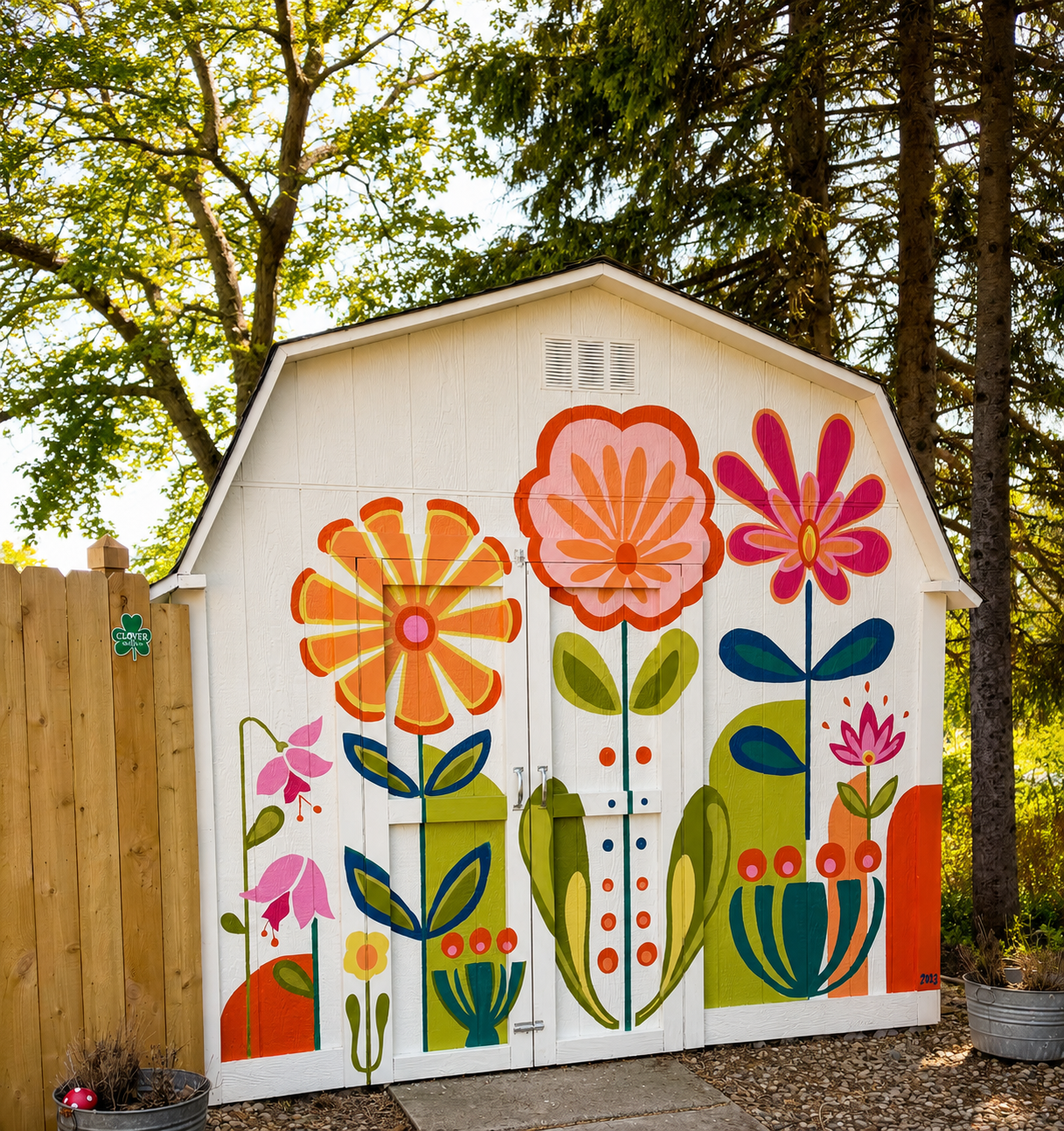 Whimsical garden shed with floral mural.png