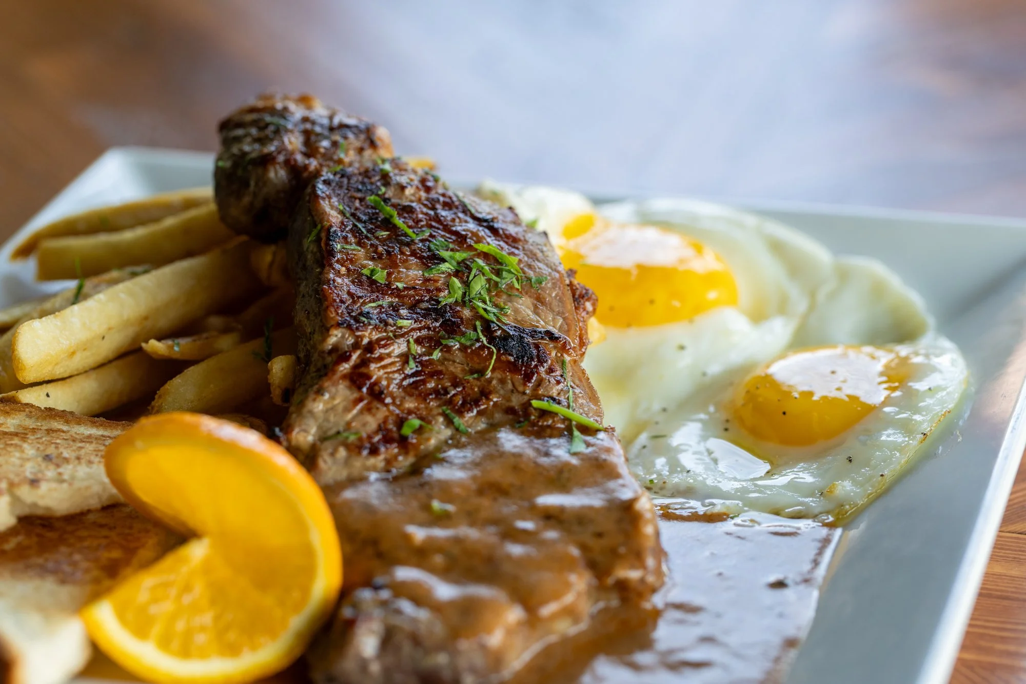 NY Strip, soft Eggs, chimichuri, fries and toast