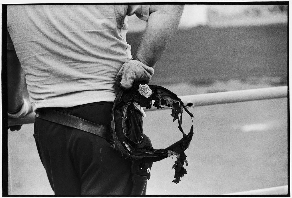 State trooper holding burnt cap of a guard taken hostage during riot at Attica State prison.